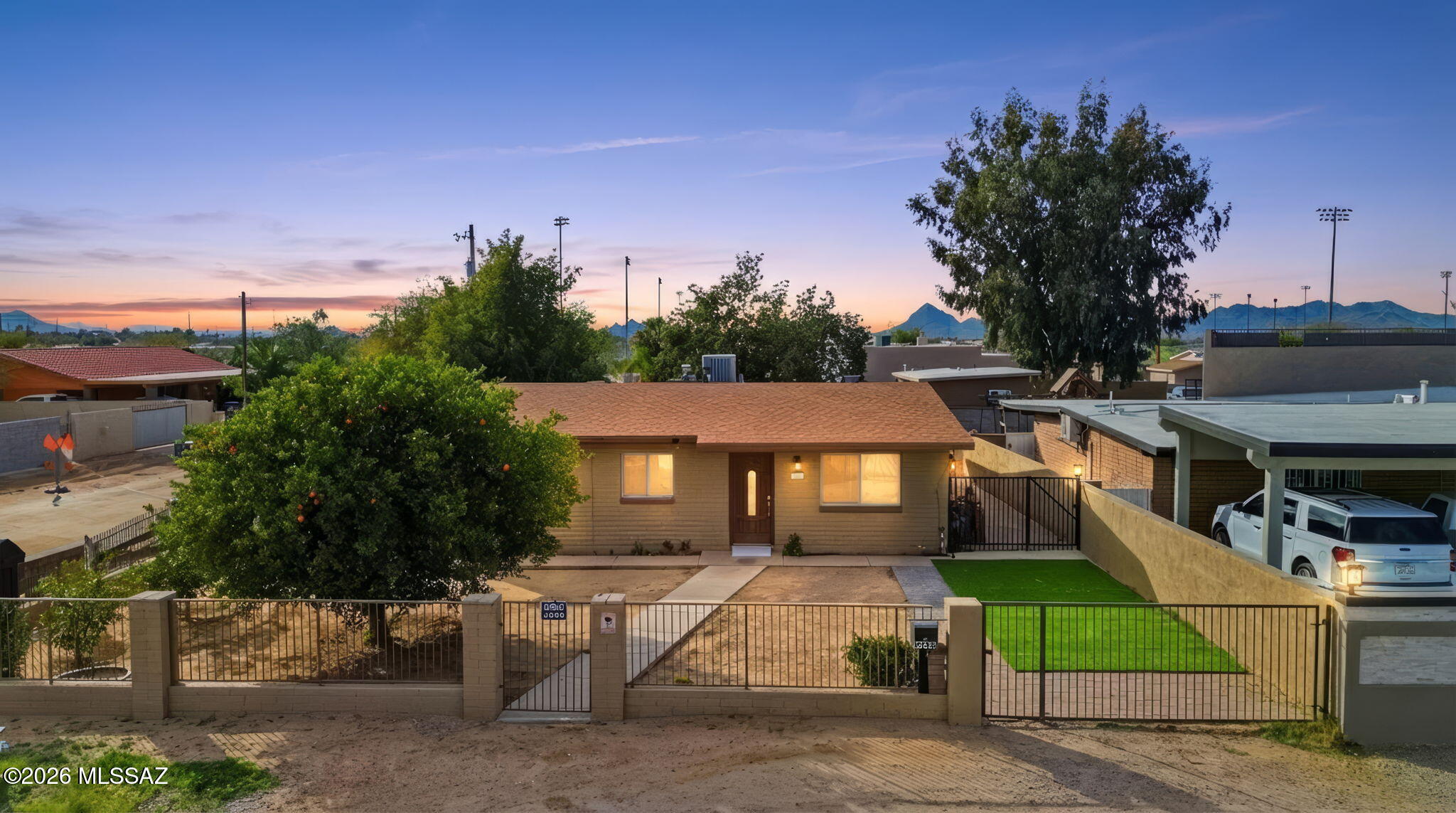 This exceptional corner-lot home offers privacy, convenience, and a true sense of community. Centrally located with easy access to I-10, the property provides seamless commuting while maintaining a peaceful setting away from city noise.
Situated in a family-oriented neighborhood featuring recent improvements and new construction homes, this residence is ideal for growing families. Enjoy direct access to paved walking and biking trails along the wash and around the nearby recreation and sports park--perfect for outdoor enthusiasts.
The low-maintenance landscaping makes everyday living easy, while mature fruit trees in the front yard add charm and character. In the backyard, mature shade trees help block the evening sun, creating a cooler, more comfortable outdoor space year-round. The fully fenced front and back yards offer both security and versatility, featuring a combination of view fencing, privacy walls, and a rolling backyard gate with an automatic opener--ideal for additional parking, recreational vehicles, or easy access.
Restaurants and shopping centers are located within a mile, giving you everyday convenience while still enjoying the quiet comfort of this secluded corner property.
Don't miss this opportunity to own a private retreat in a centrally located neighborhood with outstanding amenities and lifestyle benefits.