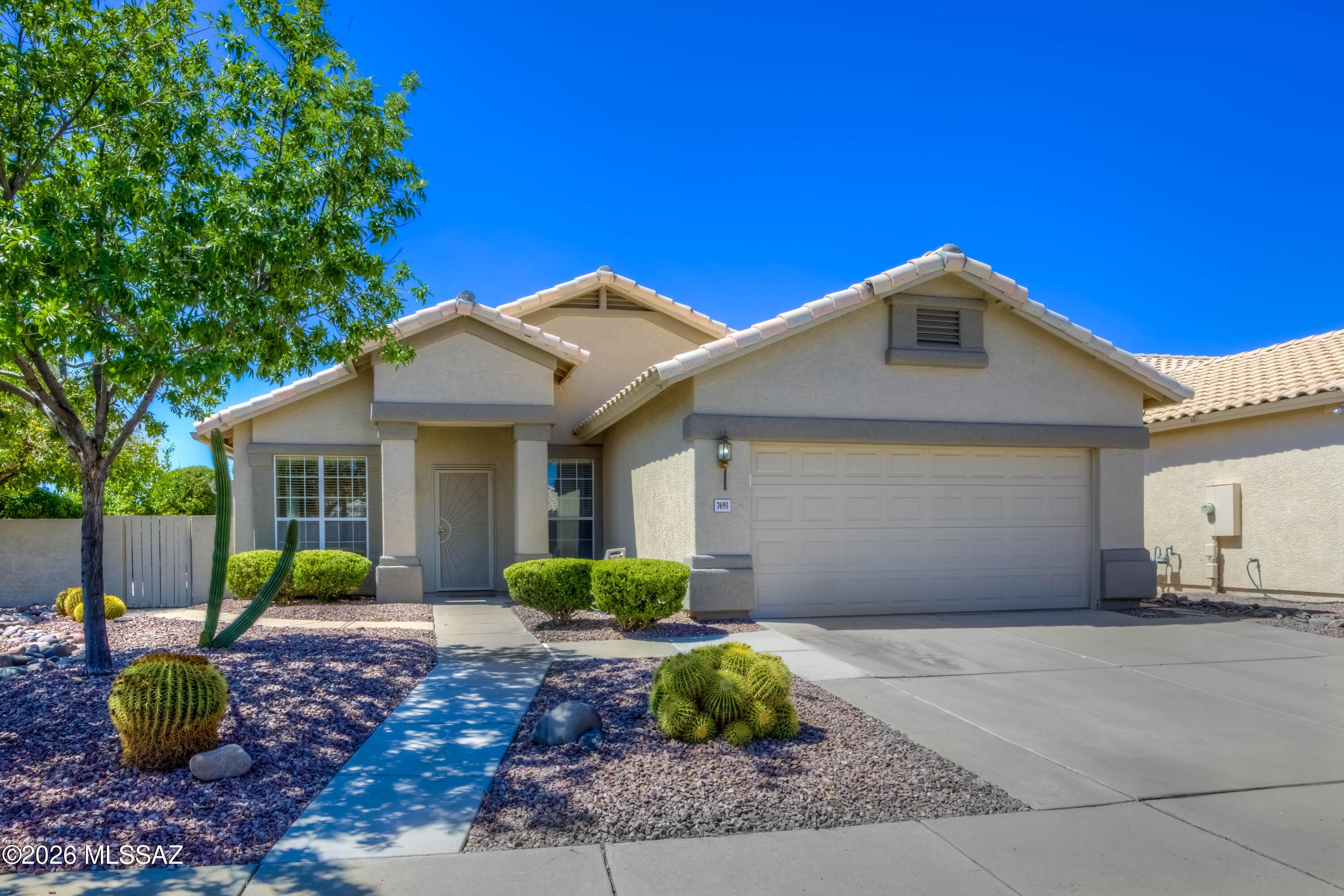 Welcome to 7695 W Summer Sky Drive
A beautifully maintained 1816 sq. ft. home situated on a desireable corner lot in Northwest Tucson.  Offering  4 BR or 3 BR plus a versitile den, playroom, or hobby space,  and 2 full bathroom, this flexible floor plan is perfect for families, remote work, or hosting guests.  Tiled throughout, this spacious home is designed with open-concept living, delivering space for bar seating and a breakfast area. The backyard oasis is landscaped beautifully with brick & stone pathways, rose bushes, and a variety of citrus trees w/irrigation system. Also offering a 2 car garage with an entry ladder into the attic and a laundry sink/utility tub.  This beautiful floor plan extends into an Arizona room and a spacious tiled covered patio.