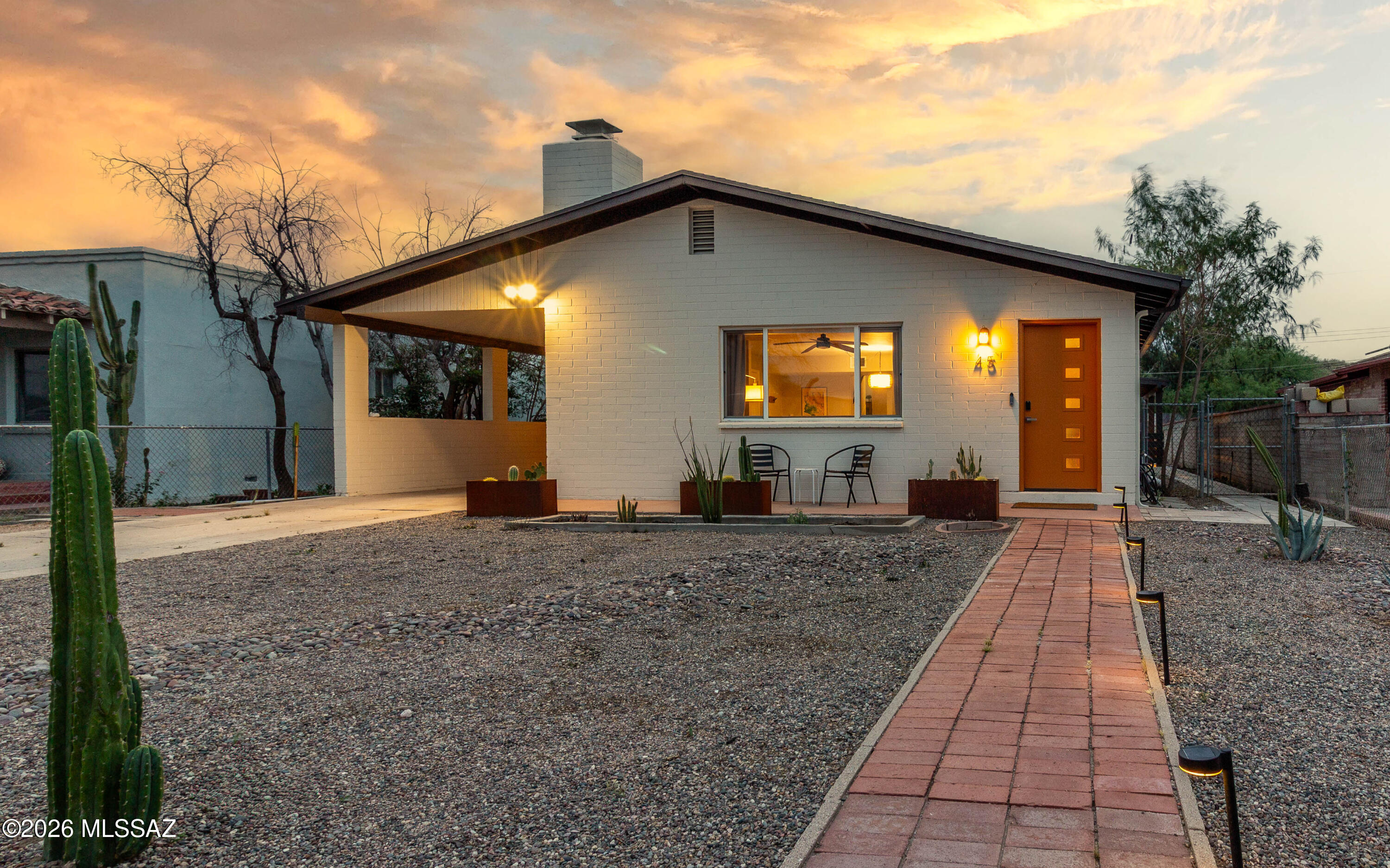 Midcentury masonry split-level in Tucson's historic Menlo Park offering space, character, and a walkable lifestyle. Just minutes from Mercado San Agustin, MSA Annex, the Streetcar, The Loop, and Downtown, this location keeps you close to it all. Inside, updated finishes meet timeless design with two wood-burning fireplaces, a brick fireplace on the main level and a stone fireplace anchoring the spacious lower level. The flexible layout offers room to live, work, or gather. Out back, enjoy a large yard with views of Tumamoc Hill and Sentinel Peak, plus alley access via rolling gate on an R-2 lot. Located in the Menlo Park Historic District with potential property tax savings for owner-occupants. Beyond the core features, this home stands out for how it lives day-to-day. The split-level design creates natural separation of space, making it easy to spread out while still feeling connected. The main level offers a comfortable gathering area centered around the brick fireplace, while the lower level becomes a more relaxed retreat with its stone fireplace and generous footprint--ideal for a second living area, workspace, or creative use.

The location ties everything together. Start your morning with a walk up Tumamoc Hill, catch the sunset from Sentinel Peak, or hop on The Loop for a ride across the city. Grab coffee or a bite at Mercado San Agustin or explore the shops and energy of MSA Annex, all just minutes away. Otherwise hop on the streetcar to destinations in and around Downtown Tucson, 4th Avenue, University of Arizona, and finally ending at University Medical Center. 

With a bike score of 91 and a location that blends historic character with modern convenience, this home offers a lifestyle that's both connected and flexible in one of Tucson's most established neighborhoods.