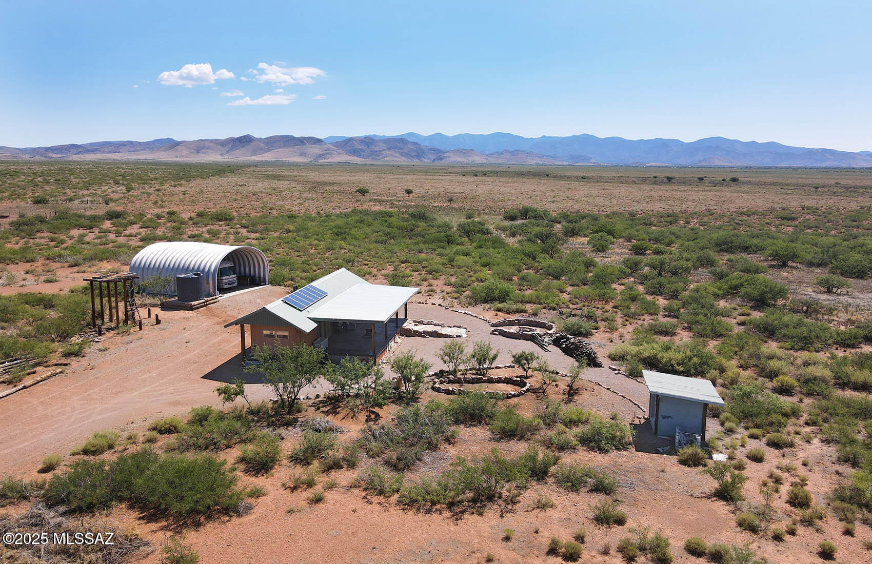 This 60-acre off-grid paradise features valuable improvements, private well and clear intimate views of the Chiricahua Mountains. Vntage mobile home w/ roof structure boasts a big back porch w/ yard & fire pit to enjoy the open skies. Quonset hut included. Solar power & compost toilet (currently no septic). For more development possibilities, power is just a few hundred feet away and Cochise RU-4 zoning allows for all kinds of options: manufactured, mobile homes or frame built dwellings OK. Borders Oak Ranch with thousands of open acres to the north and east. Exceptional seclusion with tons of potential to make your own. Come enjoy the gorgeous skies and tranquility of Southeastern Arizona country living. **Sale includes two parcels, Cochise APNs 401-77-004 & 401-77-003
