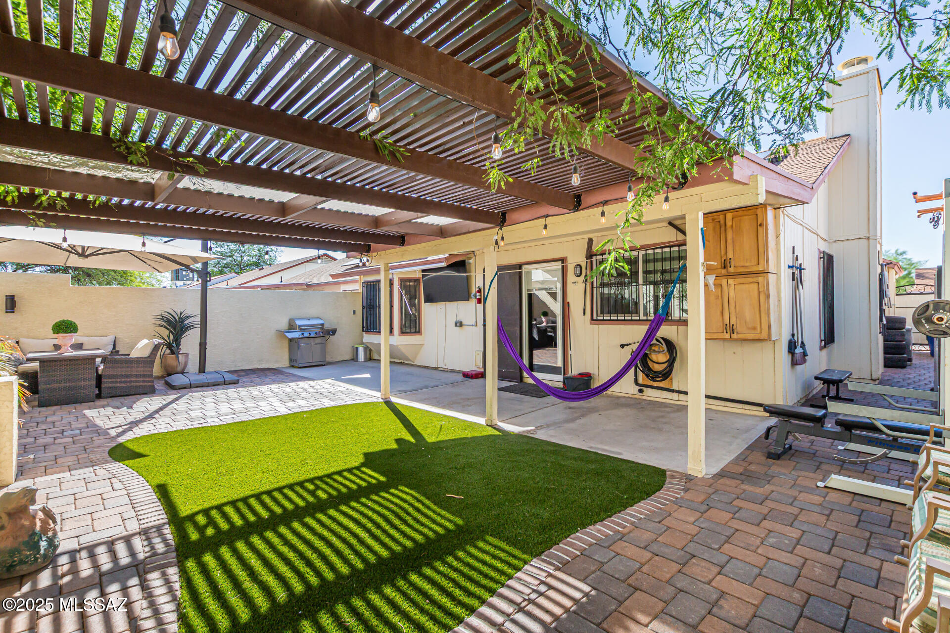 $10,000 seller concessions with an accepted offer. Welcome to Your Dream Home in Midvale Park! This stunning home offers the perfect blend of comfort, style, and convenience. Located just minutes from the Tucson Spectrum--where you'll find a variety of restaurants and shops--and with quick access to Interstate 19, you'll love the unbeatable location. Step inside and discover a home that has been thoughtfully updated throughout the years. The inviting front elevation features extensive paver work, lush landscaping, and ample parking for your vehicles. Inside, you'll find modern tile flooring, energy-efficient LED lighting, and a high-quality ceiling fan in the spacious living room, all centered around an elegant marble fireplace. The completely remodeled bathroom is a true retreat, featuring a luxurious shower panel with jets and a Bluetooth speaker in the ceiling perfect for enjoying your favorite tunes. Each bedroom is equipped with custom closet systems, the latest lighting, and stylish ceiling fans for year-round comfort.
The heart of the home is the remodeled kitchen, boasting elegant cabinetry, granite countertops, and a large island ideal for family gatherings. Stove and Microwave are included, making this kitchen move-in ready. Additional upgrades include USB-equipped electrical outlets, electric blinds, and upgraded windows and sliding doors for enhanced comfort and efficiency.

Step outside to your private backyard oasis, where you can relax under the shade of a beautiful pergola. The yard features pavers, low-maintenance artificial grass, a dedicated planting area with irrigation, and ambient lighting for magical evenings outdoors.

Major systems have all been recently replaced, including the roof, air conditioning, plumbing, and electrical panel. The home also comes equipped with a security camera system and solar panels, offering peace of mind and significant savings on your monthly energy bills.

This home has been lovingly maintained and upgraded by its current owners, who are only moving because their family and business have outgrown the space. They hope to pass this special home on to someone who will truly appreciate and enjoy all it has to offer ideally a first-time buyer, a growing family, or someone looking to retire in comfort.

Garage was converted in to an extra bedroom and one extra room that is currently being use as a bedroom.

Don't miss your chance to own this exceptional property in Midvale Park schedule your private tour today!