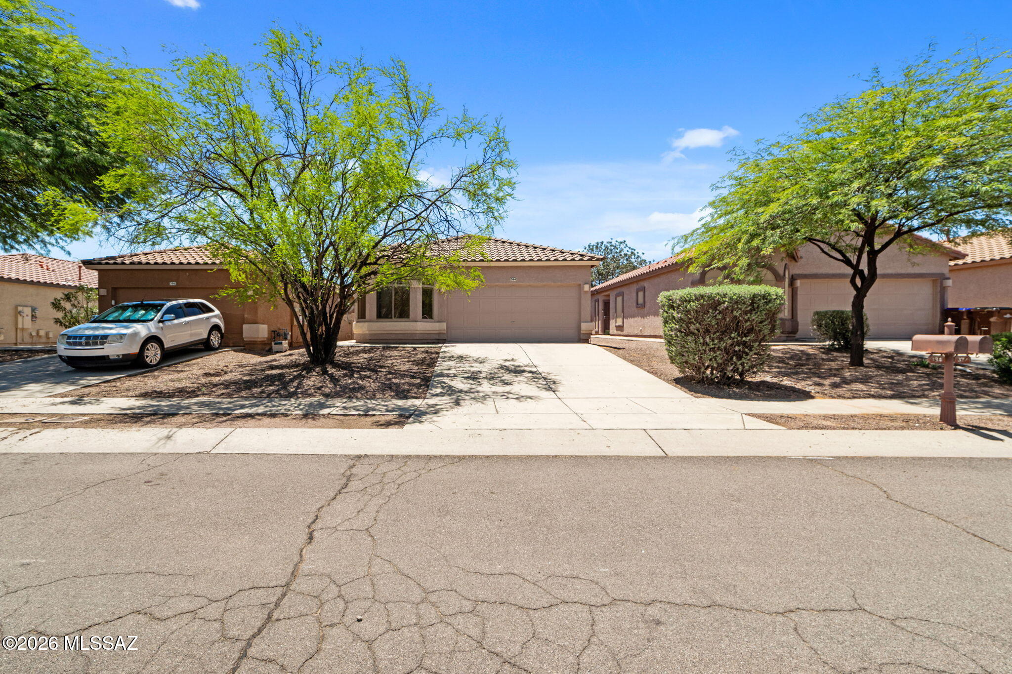 Great opportunity to make this 4bdrm/2bath  home your own in the sought-after master planned community of Rancho Sahuarita. This great room floor plan plan has an open living space perfect for everyday living and entertaining. The kitchen features a center island, gas range, white appliances, light oak cabinetry, ceramic tile flooring, & a dining nook that flows seamlessly into the living area. The spacious primary suite includes a walk-in closet, single-sink vanity, & private water closet for added privacy. Carpet throughout the living areas & bedrooms creates a warm, inviting feel. Living in Rancho Sahuarita means enjoying all the community amenities, including a fitness center, resort style pools and spa, scenic lake with walking & jogging paths, clubhouse, parks & playgrounds. Must see