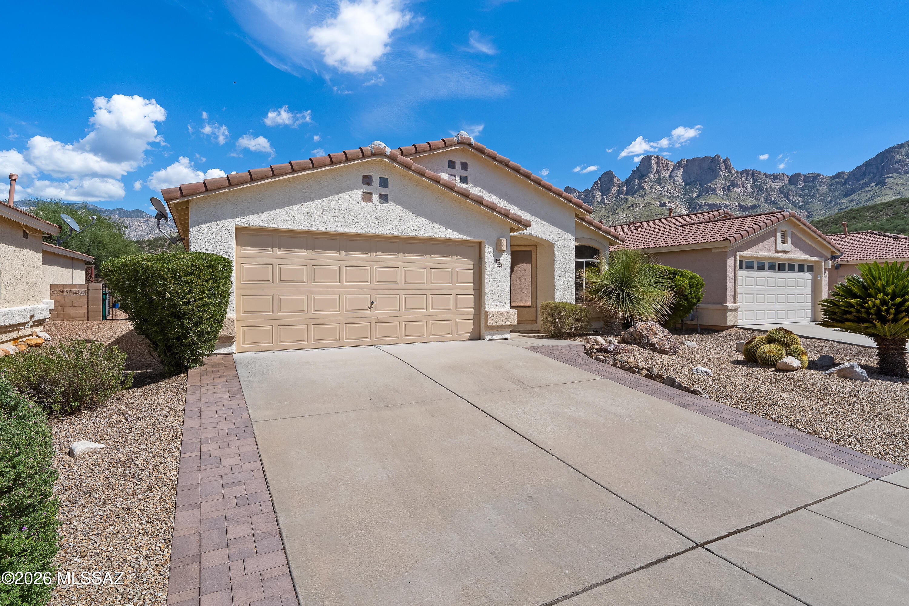 Views of the Catalina Mountains await in this beautiful, well-maintained home tucked quietly in the back of sought-after Rams Canyon. Backing to serene open nature space, this rare find seamlessly blends peaceful privacy with ultimate convenience. Walk to Catalina State Park or take advantage of nearby shopping, dining, and endless trail systems including quick access to ''The Loop''. This floor plan features a formal living/dining room plus a separate open-concept kitchen, breakfast area, and cozy great room with a fireplace. Retreat to the primary suite boasting a newer walk-in shower. Come sit on your back patio with a cold beverage and enjoy the flora, fauna right in your own backyard.