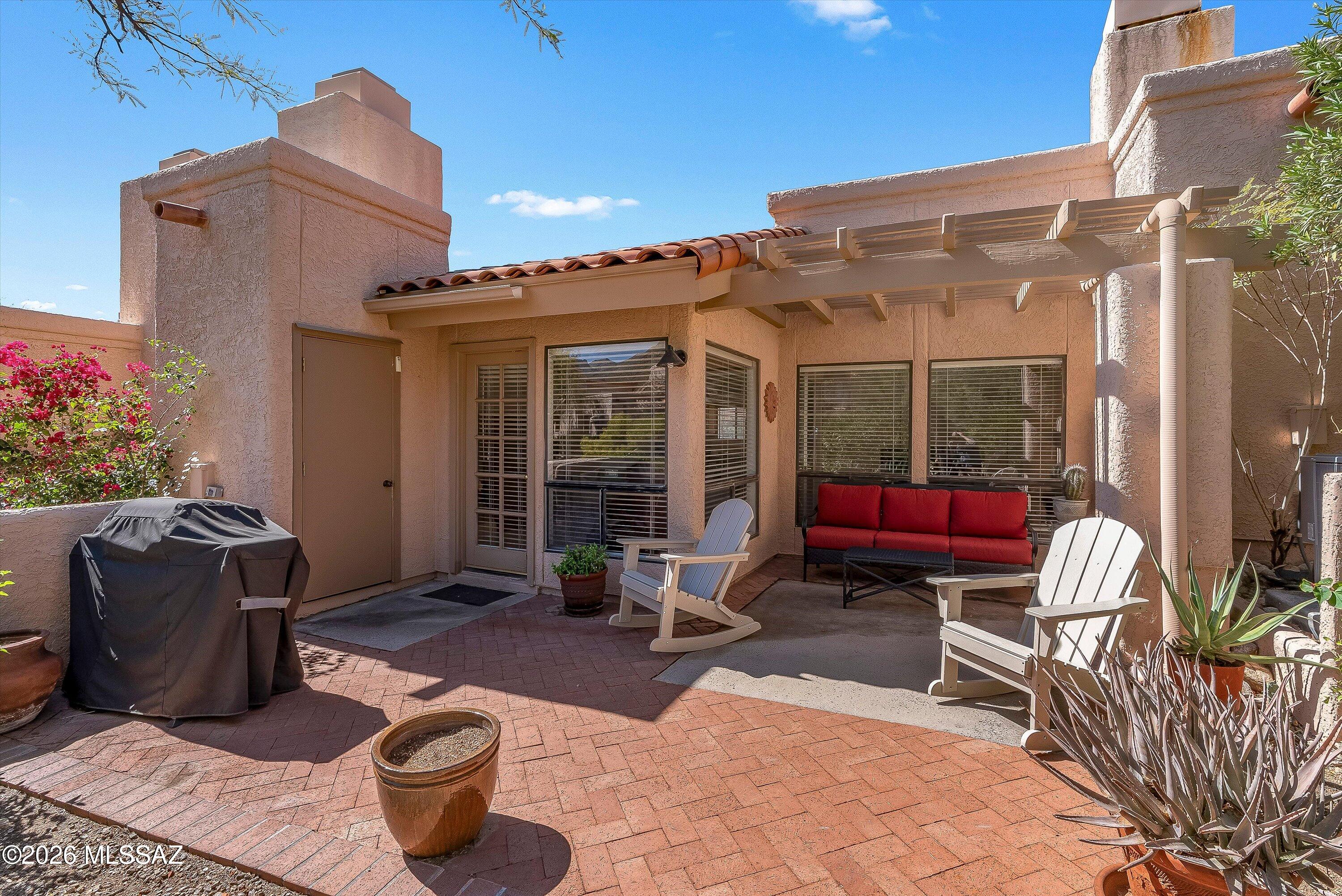 Don't miss this opportunity to own an affordable, beautifully updated townhome in this luxury, resort-like community.  This unit boasts gorgeous quartz countertops in kitchen and bathroom and custom cabinets and vanities.  The primary bedroom features a walk-in closet and its own vanity and sink. The wood burning fireplace is an inviting focal point in the living area and perfect for cozy desert evenings and entertaining. The patios offer a quiet spot to extend your living space and take in the Sonoran Desert wildlife. The HOA allows for non-permanent fences/walls so your dogs can also enjoy being outdoors.  Roof new in October 2025.  See more... This secluded, gated community offers a heated pool, fitness room, and clubhouse.  HOA fee pays for landscaping, roof and exterior maintenance, water/sewer/trash, carport and road maintenance, and termite control.  Furniture offered on a separate bill of sale.  The sellers will pay the first 2 months HOA with acceptable offer.  No site-unseen offers, and buyers must be represented by Realtors.