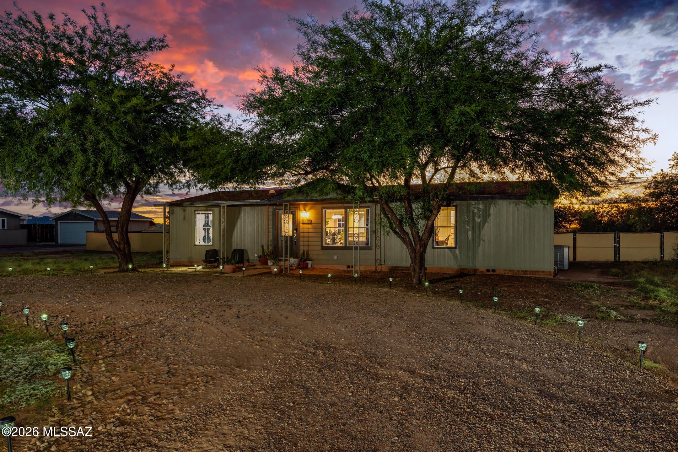 Enjoy mountain views and room to spread out on this 1.07-acre corner lot in the Picture Rocks area. This 3-bedroom, 2-bath manufactured home offers approximately 1,431 square feet with a split-bedroom floor plan, a spacious great room, and a dedicated dining area. The kitchen features a gas range and stainless steel appliances, while a separate laundry room adds everyday convenience. The primary suite includes a walk-in closet and a bathroom with dual sinks, a corner soaking tub, and a separate shower. Outside, natural desert landscaping and mature trees complement the rural setting. Chain-link fencing, a circular gravel driveway, storage sheds, and space for RV parking add practical appeal. Nearby Saguaro National Park offers opportunities for hiking and exploring the Sonoran Desert. A welcoming property with comfortable living space and room to enjoy the outdoors. Your next chapter starts here!