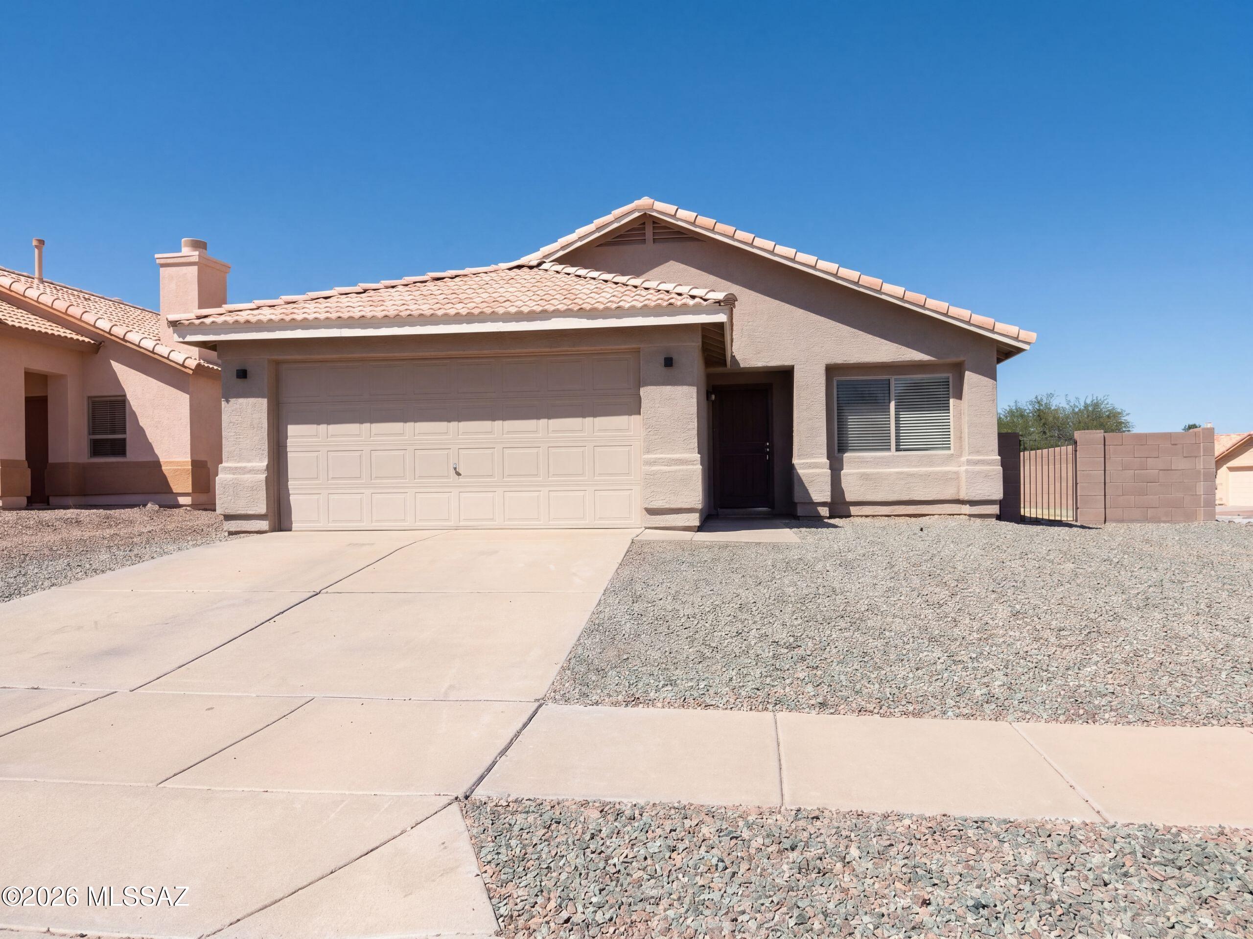 INCREDIBLE BUYER INCENTIVES: $4,000 MORTGAGE CONCESSION. Seller will pay up to $4,000 at closing towards your interest rate buydown if you finance with lender of sellers choice.

7718 S Titanite Ln is a 1-story Tucson home with three bedrooms, two bathrooms, and a corner-lot setting in Rancho Elegante at Rita Ranch. Warm-toned cabinetry and stainless steel appliances frame a wraparound peninsula, keeping kitchen preparation areas connected to the adjoining living space. Two separate living areas provide flexibility for seating and dining. The primary bedroom includes a walk-in closet and an adjoining bathroom with double sinks and a tub/shower combination. Outdoors, a covered patio overlooks the fully fenced backyard and its palm tree. An attached two-car garage complements the home's si