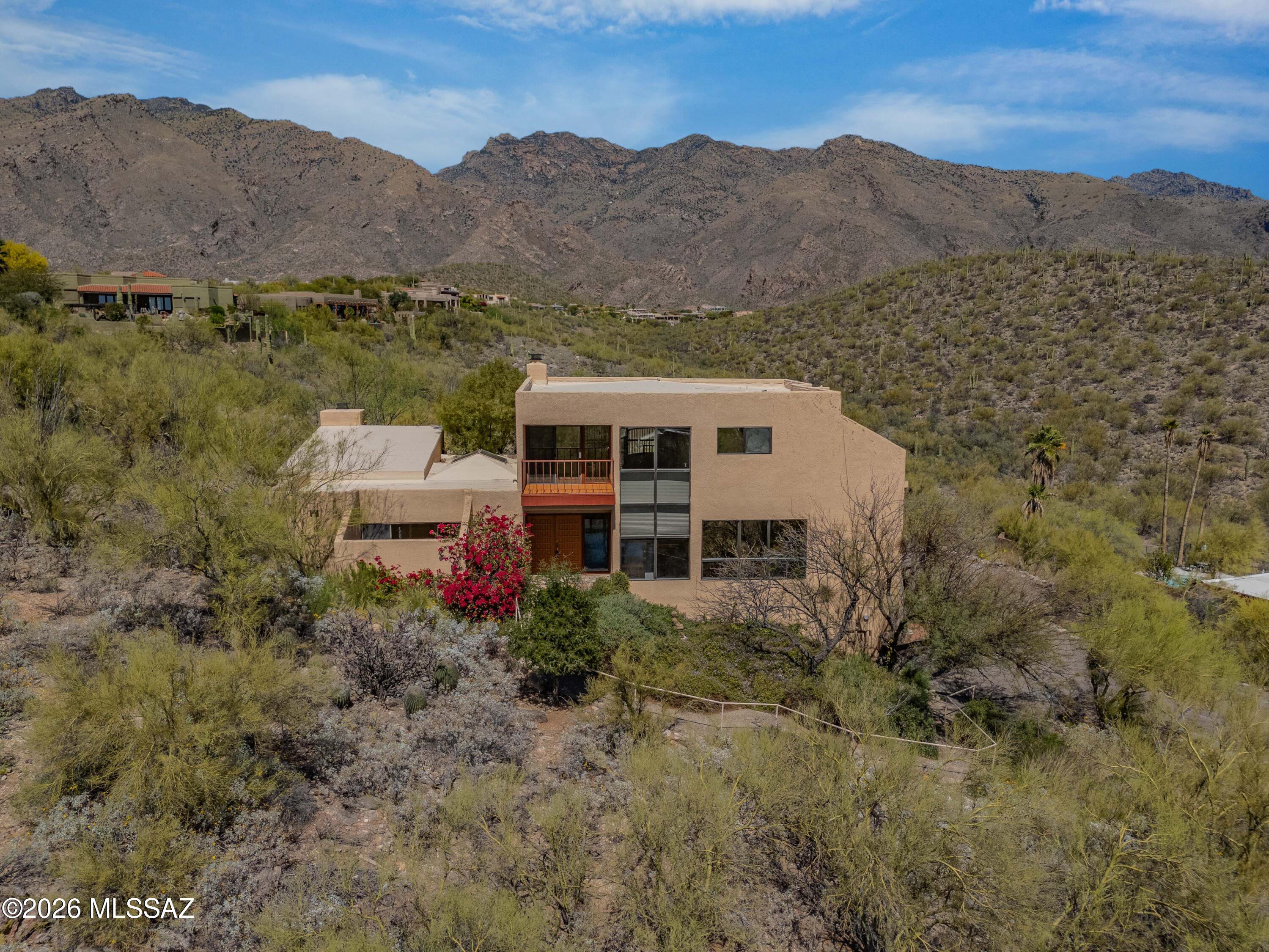 Tucked away in Cimmaron Estates, this split level home is done right: easy access ( no stairs) to the main floor with features all you need for daily living: comb kitchen family rm. formal dining room, gorgeous and elegant two story high living room w/ spectacular mountain views & fireplace, and best of all,  a romantic primary suite with oversized jetted tub, fireplace, and lanai/atrium entry to set the mood.  Upper level features an open library loft, two bedrooms and full bath.  Lower level is a two room guest suite with private entrance and full bath.  Lush landscaping and a deck on the north side of home to watch the sunrise is easily accessible from the living room.  
All freshly detailed and move in ready.