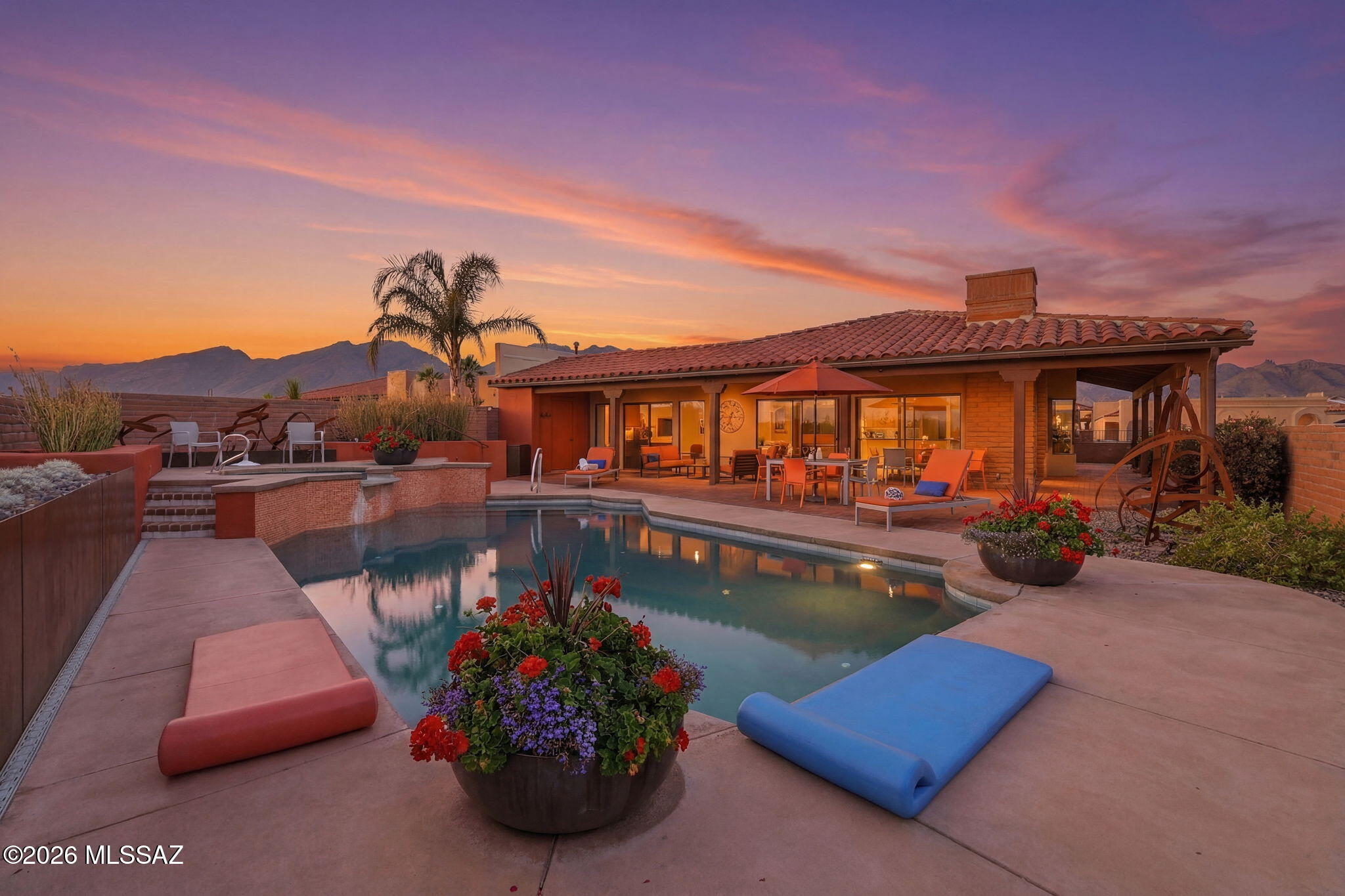 Perched on a private knoll above Fairfield, this desert oasis delivers it all: fiery sunrises over the Rincons, golden sunsets, and Tucson's glittering lights spread across the valley below. Soaring ceilings, sun-drenched rooms, and blond hardwood floors set a stunning tone. The gourmet kitchen shines with a Viking 6-burner range, KitchenAid 65'' counter-depth fridge, granite counters, and custom cabinetry. The great room flows through wide sliders to a private pool, jacuzzi, and jaw-dropping views. The expanded primary suite offers a peaceful reading nook with direct pool access. A charming guest bedroom frames the Rincon range. Third bedroom is a polished home office. **Self-managed HOA offers: Pickleball, Bocca ball & Tennis courts, 2 heated pools, HOA owned private roads & more!