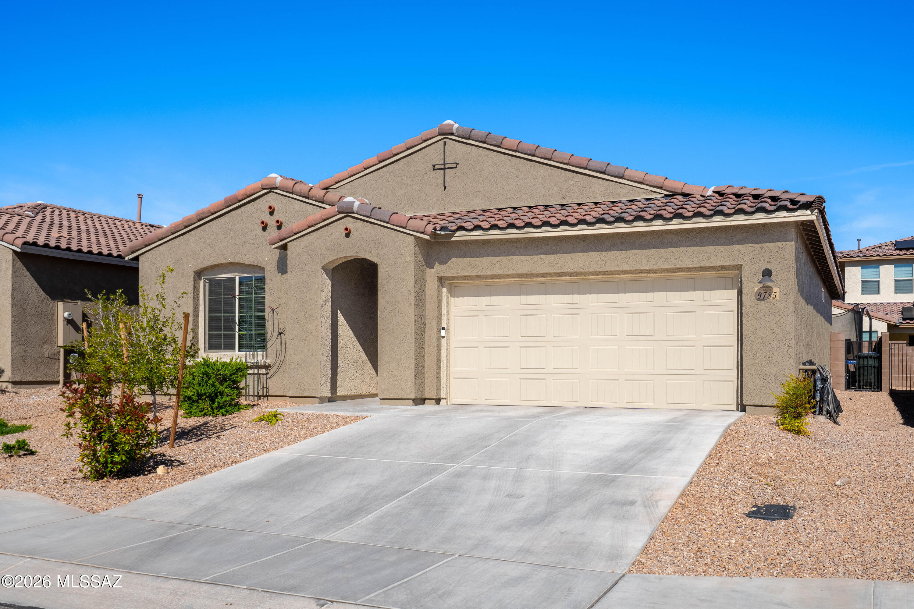 Elegant, low-maintenance living awaits! Welcome to this beautifully maintained 3-bedroom, 2-bath home in the highly desirable Saguaro Trails community, where comfort, style, and flexibility come together. Designed with today's lifestyle in mind, this thoughtfully designed layout offers spacious bedrooms and versatile living areas to fit your evolving needs.

At the heart of the home is a bright, open-concept living space anchored by a stunning granite kitchen with upgraded cabinetry, generous counter space, and a large island perfect for entertaining, meal prep, or casual gatherings. Upgraded tile flooring and modern finishes throughout create a clean, cohesive look that feels both inviting and elevated. The tandem 2-car garage is a standout feature, offering exceptional functionality along with a modified attic for additional storage--ideal for seasonal décor, hobbies, or outdoor gear. Step outside to a low-maintenance backyard designed for easy living, whether you're enjoying your morning coffee or relaxing under Arizona's beautiful sunsets.

Located just minutes from scenic trails, neighborhood parks, and resort-style amenities including a pool, clubhouse, and sports courts, this home delivers the best of Tucson living in a community known for its beauty and convenience. A perfect opportunity for those seeking quality, space, and lifestyle in one of the area's most sought-after neighborhoods.