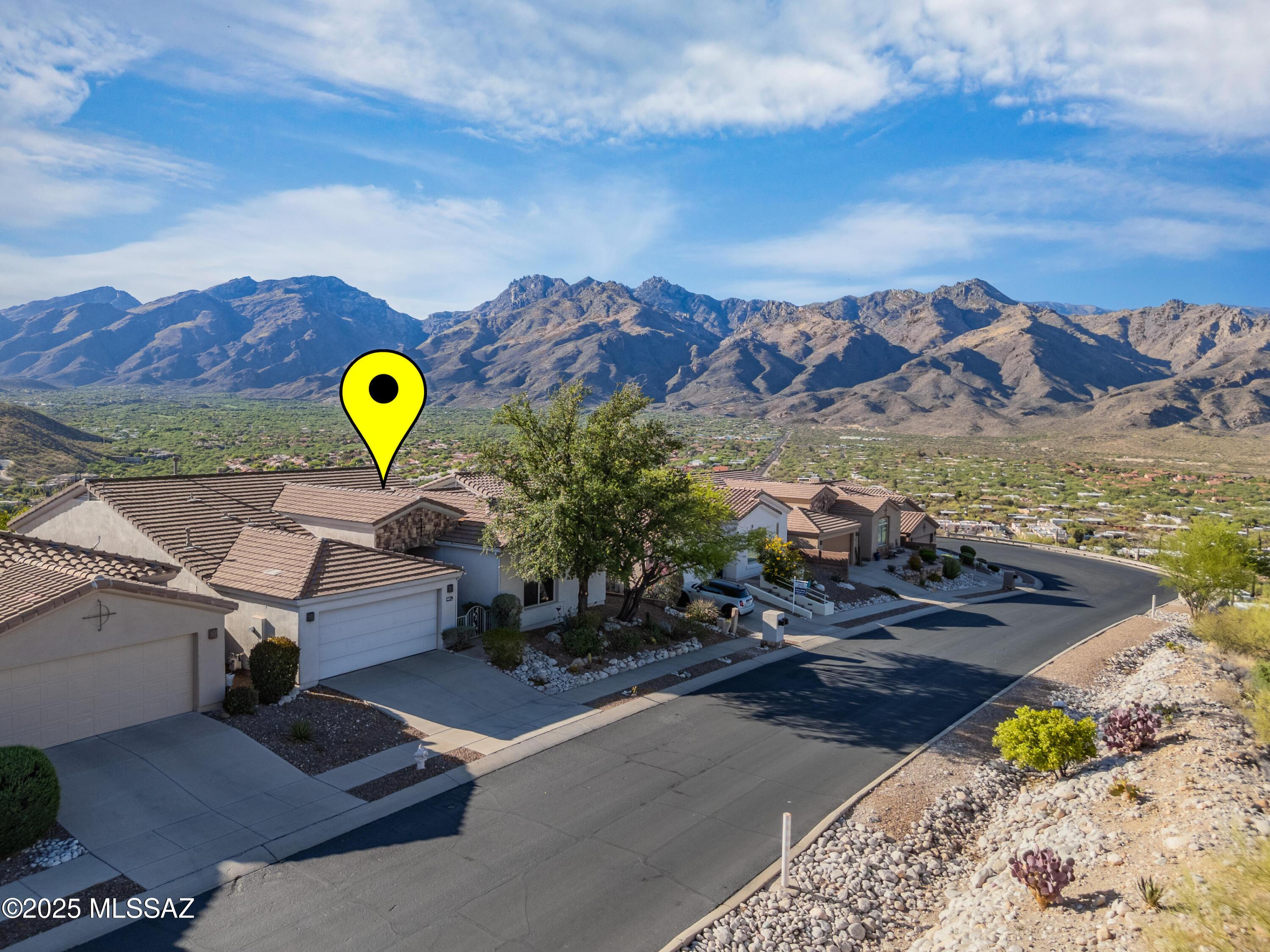 VIEWS! VIEWS!! MOVE-IN READY. ThIS STUNNING HOME has BREATHTAKING panoramic RARE VIEWS of BOTH Catalina & Rincon Mountains, City/valley lights & spectacular sunsets. SEE TELESCOPES ON KITT PEAK 50 MILES AWAY! Split bedroom plan (wake up to mountain views!) plus office & GREAT ROOM with fireplace. The spacious kitchen has ample cabinetry, UPGRADED granite countertops, Bosch/Kitchen Aid double ovens. Note high ceilings. Neighborhood friendliness abounds due to a short cul-de-sac, that also limits traffic. NEWER AC, NEWER ROOF, NEWER CARPET, NEW PAINT INSIDE & OUTSIDE (FEB 2026!). NEW EPOXY GARAGE FLOORING. Note the WATER FILTRATION SYSTEM in garage. Close to TMC hospital, fine dining, shopping, medical offices, hiking & biking. GO THRU THE BACK GATE TO THE RIDGETOP - YOU WILL BE IMPRESSED