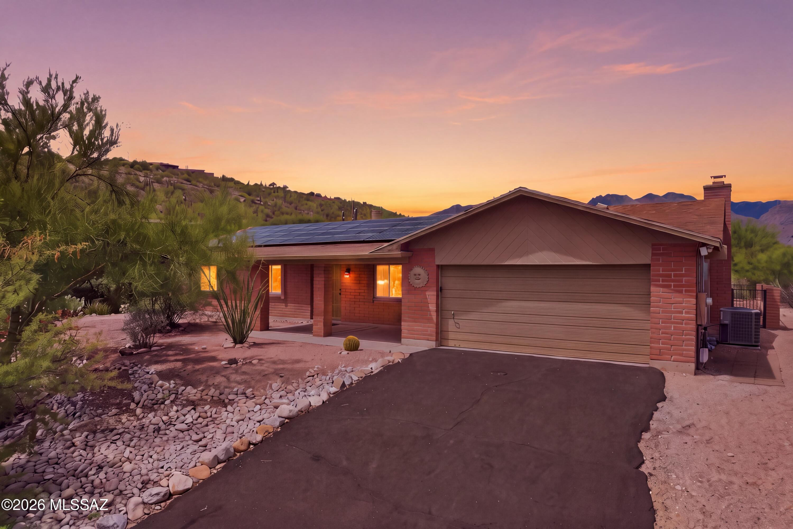 Remodeled and move in ready! Terrific location near Sabino Canyon on a quiet street. Great mountain views from the backyard and city views from the front patio. This well maintained home features a remodeled kitchen and bathrooms and fresh interior and exterior paint. OWNED SOLAR SYSTEM for energy efficiency and long-term savings.  Primary bedroom with private bathroom. Fully tiled throughout the home with no carpet. The garage is equipped with an electric vehicle charging system and storage cabinets. Large lot is .42 acres which leaves room for privacy and a long driveway with plenty of parking. Backyard features covered patio, fully fenced area with a storage shed too. Located in the desirable Catalina Foothills close to shopping, schools, restaurants & Sabino Canyon Recreation Area.