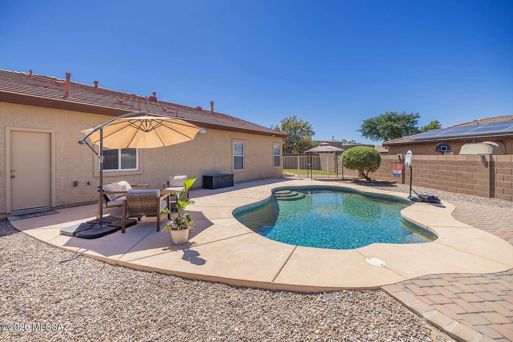 Situated in the desirable Continental Reserve community, this well-maintained single-story home offers 2,481 sq ft of thoughtfully designed living space on a spacious 10,237 sq ft lot. Featuring 3 bedrooms, 2.5 baths, and a split-bedroom floor plan, the home blends comfort and functionality with high ceilings, abundant natural light, and a welcoming great room concept. The spacious kitchen offers ample prep space and is ideal for both everyday living and entertaining. The primary suite provides a relaxing retreat with dual vanities and a generous layout. Step outside to a private backyard oasis featuring a sparkling Pebble Tec pool and covered patio--perfect for entertaining and enjoying Arizona living year-round. A Tesla solar system adds energy efficiency and long-term savings. Located near parks and community amenities, this home combines convenience, comfort, and lifestyle.