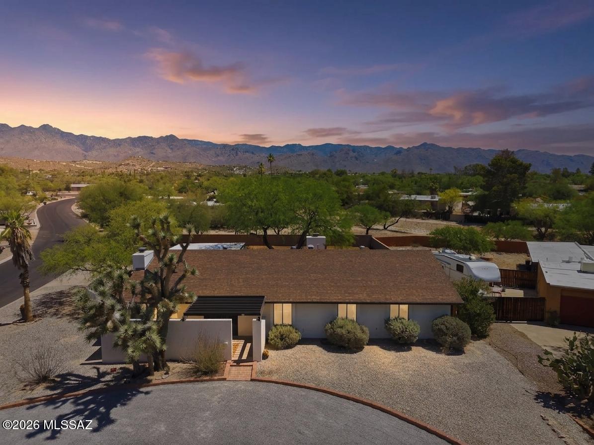 Unique opportunity for 4 bed/2.5 bath, 2,509 SqFt single story 1972 masonry stucco Mid-Century Modern Ranch on premium .43 acre CR2 corner lot with no HOA, space for RV/camper parking, daily Catalina mountain views located on whisper quiet street in desirable Sabino Vista neighborhood in North Tucson. Searching for character and charm? Yearning for nostalgia?? This vintage home is the next best thing to owning a time machine! Rare find priced below the $590K RVM property value report and below the Zillow ''Zestimate''. Owned by the same family since 1976 and offered for sale for the first time, this home showcases exceptional pride of ownership.
Featuring N/S orientation, architectural shingle roof, round driveway, 571 SqFt covered multiple car carport, expansive concrete driveway, on & o street parking, massive front mature Josha tree, masonry stucco walled side courtyard w/large mesquite shade tree, metal security doors and set of double wood doors. Step inside the foyer featuring original honey saltillo octagon flooring, textured natural seagrass wallpaper, step down into sunken living room with amazing natural light and wood burning fireplace, formal dining room, original light fixtures and hardware, original wood internal doors, wood siding, wired for alarm, copper plumbing, Trane gas HVAC (new 2023), digital thermostat, copper plumbing, gas water heater (new 2023), intercom speaker system, laundry room with half/bath washer and dryer included. Wonderfully preserved vintage kitchen that captures the charm of a bygone era with yellow flowered-powered flooring, original avocado green 1973 Hotpoint dual oven, ample countertop space, original wood cabinets, peninsula counter with bar seating opens to spacious family room with stacked rock wood burning w/gas option fireplace, dining area with cool atomic telescoping light. Spacious bedrooms, guest bathroom w/executive height dual sink counter, fabric wallpaper, shower and tub. Large primary suite featuring slider to private backyard, ensuite full bathroom with dual sink counter, walk-in shower and exhaust fan.
Enjoy tranquil Tucson sunsets under extended covered 360 SqFt backyard patio, low maintenance backyard with omnipresent Catalina mountain views, gate access, storage shed with power, all surrounded by block privacy walls. The expansive lot provides ample space for a future swimming pool, outdoor entertaining areas, guest quarters, or simply enjoying the beauty of the Sonoran Desert.
Located walking distance to highly ranked Fruchthendler Elementary School, Tanque Verde Wash, the Chuck Huckelberry Loop ("The Loop") is a 131-mile, paved, shared-use path encircling the city and connecting with neighboring communities. It's designed for walking, biking, skating, and even horseback riding, offering a safe, car-free environment for recreation and commuting. Minutes away from acclaimed Sabino Canyon Park, Udall Park, shopping, groceries, pharmacy, banking and restaurants. 
This is your chance to own a piece of Tucson history while it is still available. They simply don't build houses like this anymore, call to make your appointment to view today!!