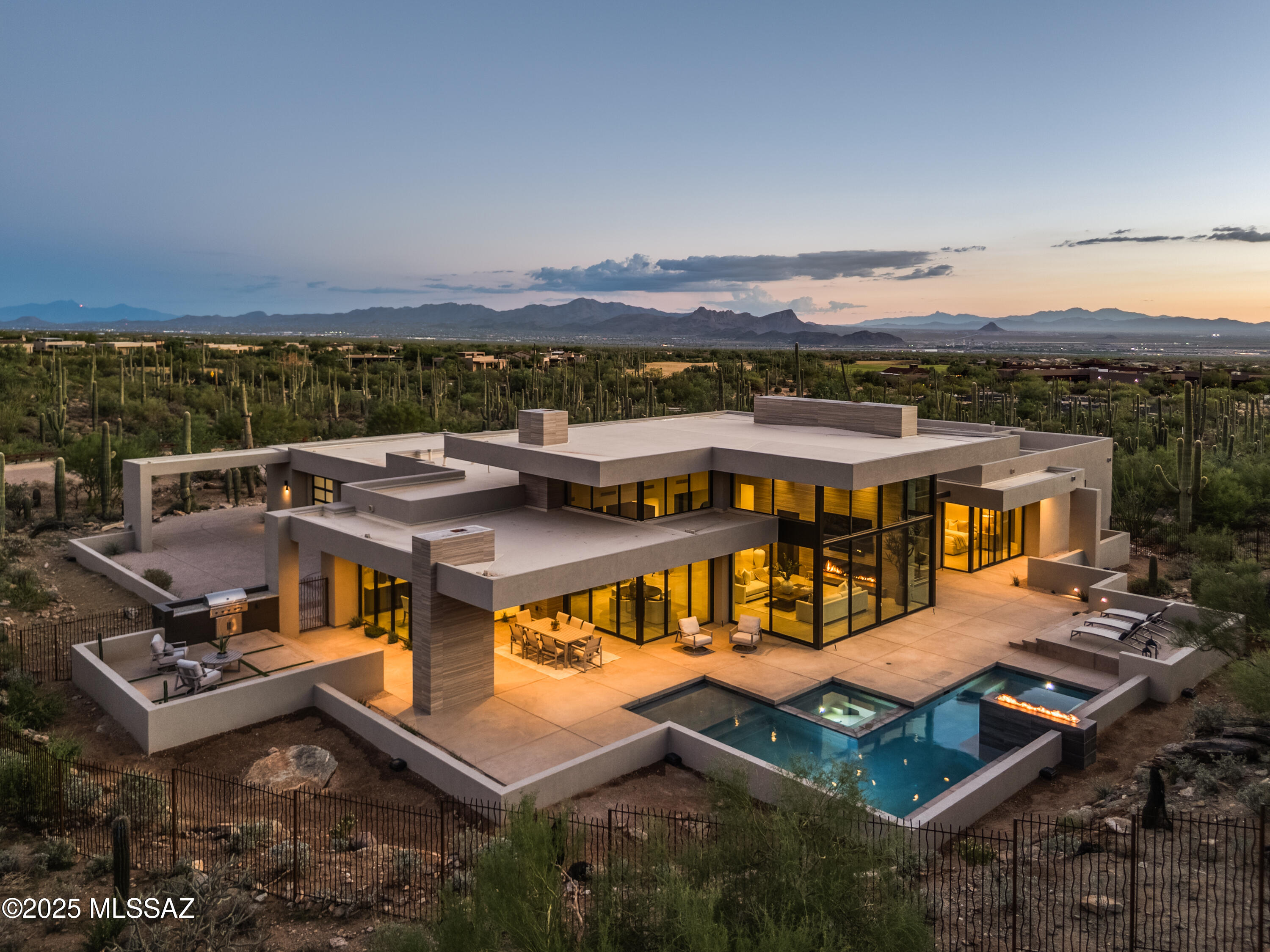 THE EPITOME OF LUXURY IN THE PRESTIGIOUS RITZ-CARLTON COMMUNITY. TAKE RESIDENCE IN TUCSON'S MOST COVETED ENCLAVE FOR EXCLUSIVITY & PRESTIGE. UPON ENTERING THE GRAND ENTRYWAY YOU ARE ENTERING A WORLD OF REFINEMENT, SOARING CEILINGS & EXPANSIVE WALLS OF GLASS REVEALING CENTURIES OLD SAGUAROS W/ CITY & MOUNTAIN VIEWS. THE OPEN CONCEPT LIVING SPACE IS ANCHORED BY A CHEF'S KITCHEN & APPOINTED WITH A WALK-THRU SCULERY COMPLETE WITH A SECOND KITCHEN, HIGH-END APPLIANCES & ITALIAN CUSTOM CABINETRY FOR EFFORTLESS ENTERTAINING. EXPANSIVE COVERED PATIOS ARE PERFECT FOR INTIMATE GATHERINGS OR GRAND SOIREES. THE PRIMARY SUITE HAS A SPA INSPIRED SHOWER/BATH & WORKOUT AREA. ENJOY WORLD-CLASS RITZ CARLTON SERVICES AND AMENITIES ENSURING EVERYDAY IS DEFINED BY LUXURY AND INDULGENCE. DESIGNED BY THE AWARD- -WINNING AND VISIONARY MIND OF ARCHITECT KEVIN HOWARD AND THE MOST SOUGHT AFTER GENERAL CONTRACTOR/BUILDER MARK ALAN/MARK ALAN HOMES LLC. TOGETHER THEY HAVE AGAIN CREATED A MASTERPEICE.