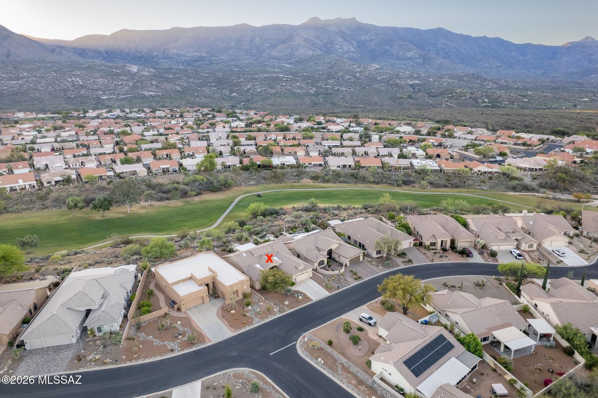 Phenomenal Mountain and elevated golf course views define this Estacia model, overlooking 3rd fairway of the Tucson course. This 2BR, 2BA plus den home offers generous storage throughout, with a spacious owners suite showcasing stunning scenery. Dramatic vaulted ceilings soaring up to 20 feet -a bright open feel. Enjoy newer luxury laminate in most rooms. A breathtaking 8 x 8 foot custom picture window in the great room perfectly frames the expansive mountain vistas, visible from nearly every room. Located in a quiet, highly desirable neighborhood the home captures sunrise and sunset views. Backyard is designed for relaxation, and entertaining featuring extensive hardscape, abundant shade, built in barbecue, and designer fountain creating a true resort style atmospher. Priced to sel
