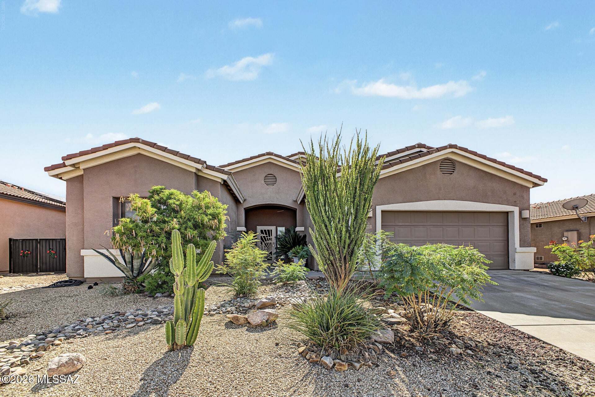 Beautiful home in Tucson Mountain Sanctuary! Offering 3 beds, 2 baths, plus a bonus room, 2-car garage, & a desert landscape. The interior exudes sophistication with a large foyer, high ceilings, tons of natural light, designer palette, and carpet & tile flooring t/out. Perfect for everyday living & entertaining, the open-concept floor plan is sure to impress! The kitchen boasts SS appliances, a pantry, recessed lighting, ample cabinetry & counter space, and a 2-tier island w/breakfast bar. Versatile den for an office or extra bedroom! The sizable main bedroom has an ensuite with dual sinks, separate tub/shower, & a walk-in closet. Check out the spacious backyard, featuring an open patio & mature tree! With your creative ideas, you can make it a complete outdoor living space.