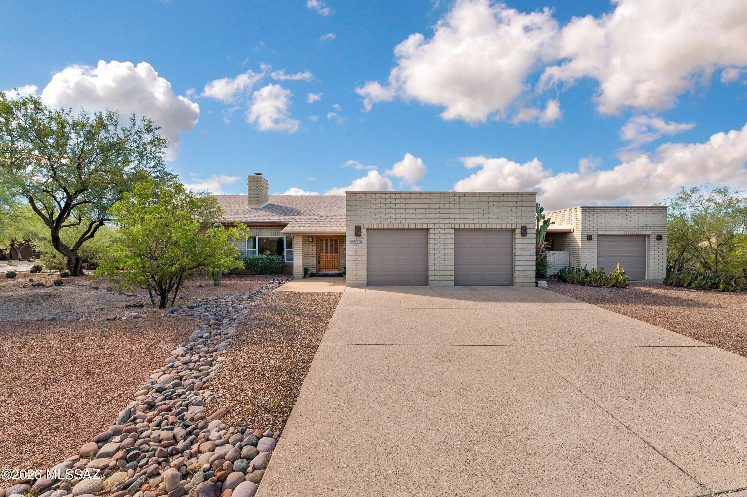 Masonry ranch-style 4 BR, 2 BA home on a 0.74-acre corner lot in the Loma De La Vista Verde subdivision in the Tanque Verde Valley. Built in 1992, this 2,613 sq ft home  features vaulted ceilings, large picture windows, and a split floor plan with Catalina and Rincon Mountain views from the main living areas. The fourth bedroom offers flexible use as a home office. The kitchen includes double ovens, an electric cooktop and a breakfast nook, while the primary suite offers a separate shower and soaking tub. Outdoor living centers on a covered patio, a sparkling pool resurfaced in 2024 and a hot tub, set against mature, low-maintenance landscaping & views. Prepaid solar PV lease, transferable through 2035, powers the home. The oversized 3 car garage includes a workshop, utility sink & storage