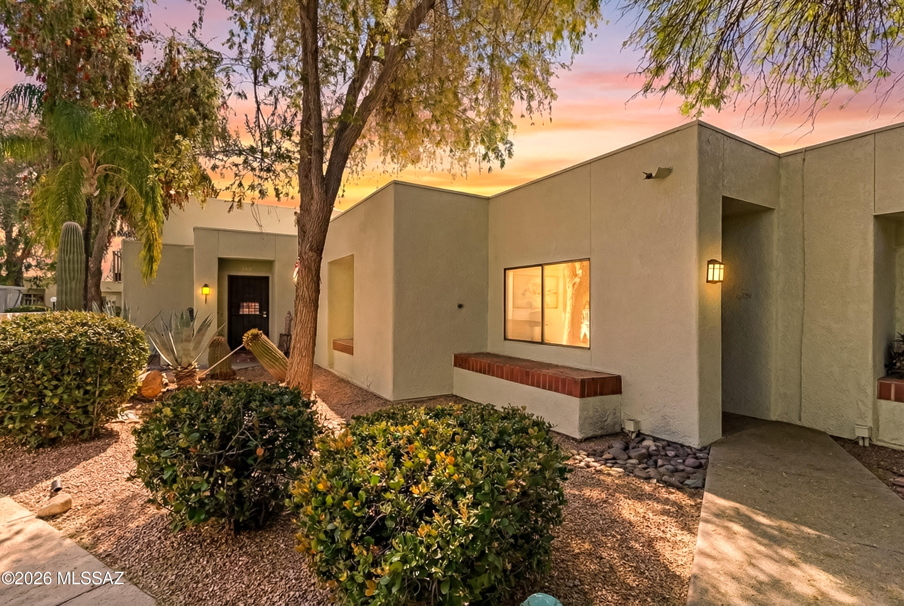MOTIVATED SELLER! MAKE AN  OFFER Wonderful single story townhome in sought after community.  Gated entrance leads you through a central courtyard with multiple fountains, lush vegetation, mature trees plus a sparkling pool, spa, and ramada to enjoy year round.  Home offers bright open great room with cozy gas fireplace, 2 generously sized bedrooms + den perfect for office or third bedroom. Split floorplan features Primary with private en-suite bath, dual vanities and both bedrooms have walk in closets.  Home includes central atrium providing tons of natural light plus a private flagstone patio.  Kitchen features wood cabinetry, gas range, newer microwave, and bright open space with multiple skylights.  2 car attached garage provides direct access for added convenience.  Brand new HVAC Feb 2026, new interior paint plus brand new carpet.  This small community of 28 homes is tucked away yet offers great location close to shopping, restaurants, and amenities. HOA covers the exteriors plus property insurance so only a condo policy is recommended which helps offset the HOA dues for additional savings.  Perfect for anybody looking for low maintenance living in a quiet and serene setting.