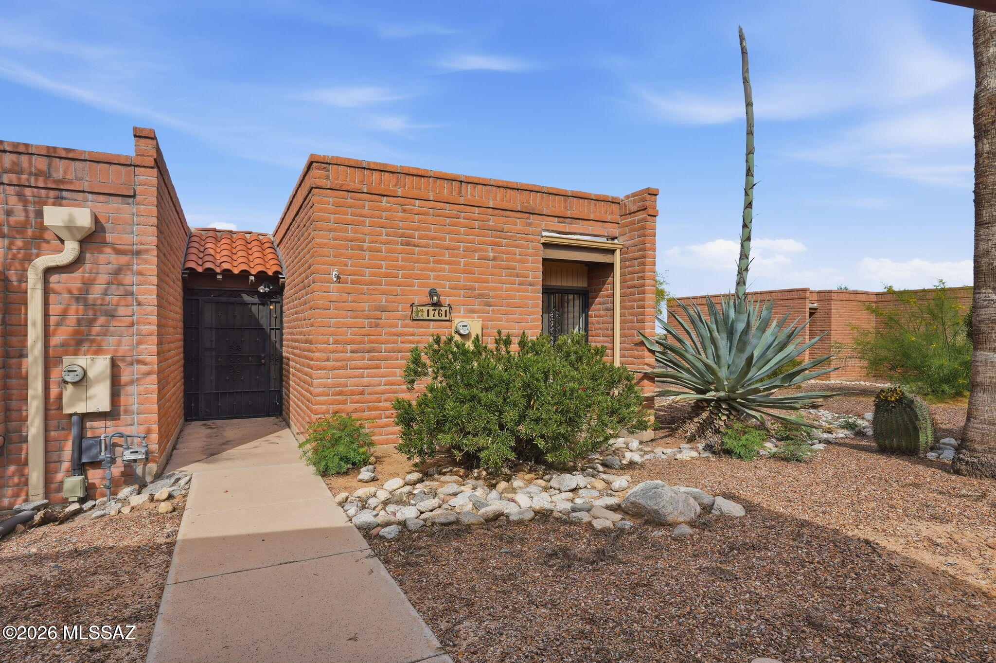 Enjoy easy, low maintenance living in this charming 2 bed/2 bath townhouse in the desirable age restricted La Cholla Hills community. This single level home offers a bright living area, skylights, high ceilings, and a well-appointed kitchen with stainless appliances and pantry storage. Relax on the paver patio and take in the beautiful mountain views from the low care desert landscaping. Additional features include ceramic tile and engineered wood flooring, bath grab bars, and a covered carport. Residents enjoy community pools, tennis, and shuffleboard, plus convenient access to shopping, dining, and major routes. A wonderful lock and leave retreat in a peaceful Northwest Tucson setting.
