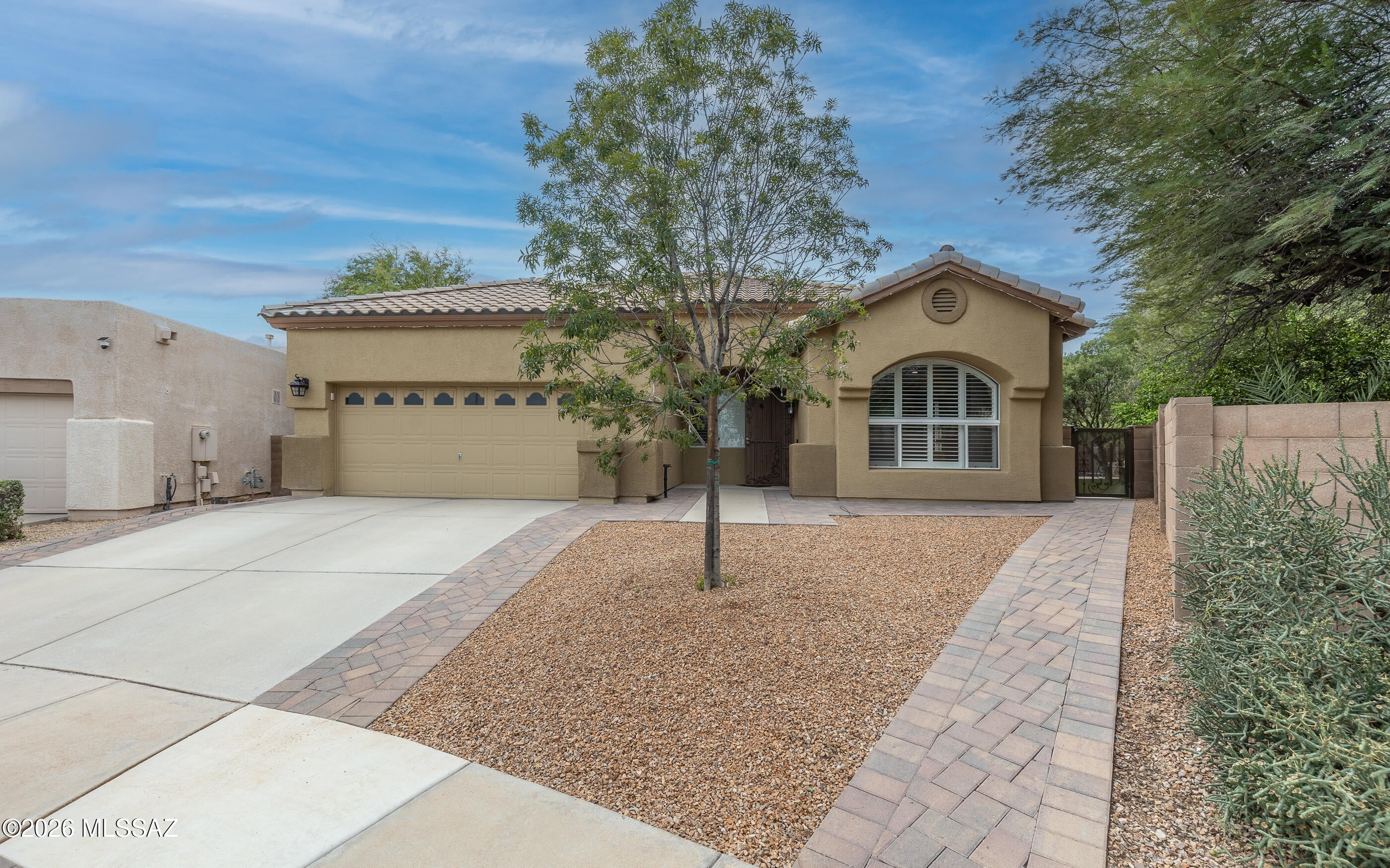 Welcome to this beautifully remodeled home in a highly desirable neighborhood near Starr Pass, perfectly positioned on a quiet cul-de-sac backing to a scenic wash for ultimate privacy and desert views.

This home has been thoughtfully upgraded with high-quality finishes throughout. Inside, you'll find tile flooring installed throughout in 2023, a cozy built-in fireplace with custom backing, new baseboards, custom blinds, and upgraded lighting including custom LED lighting with dimming and color-changing features, recessed kitchen lighting, and ceiling fans in every room. Details like brushed nickel door handles, security doors, and upgraded outlets with built-in USB ports complete the modern feel. The chef's kitchen is a showstopper featuring LG Monogram double oven, cooktop, and dishwasher, granite countertops and island with built-in refrigerator, glass tile backsplash, crown molding on cabinets, kitchen skylight, and wine fridge under island.

Bathrooms have been tastefully updated with custom tile showers including a custom master shower tiled in 2024, tile flooring, granite vanities, upgraded shower head, and new toilets in 2023.

Step outside to your private resort-style backyard. The custom gazebo is an entertainer's dream with automatic retractable shade, outdoor TV, ceiling fan, mini fridge, and built-in bar with countertop plus gas grill. Enjoy low-maintenance artificial turf, custom pavers, and storage shed.

The sparkling pool (installed 2022) features a new pool deck, pebble tec, tranquil waterfall feature, and custom pool cover.

Additional upgrades include new main water line, water softener system, Rheem 50-gallon gas water heater (2023), HVAC (2017), and central vacuum system.

Don't miss this move-in ready Tucson gem offering luxury, privacy, and indoor-outdoor living at its finest.
