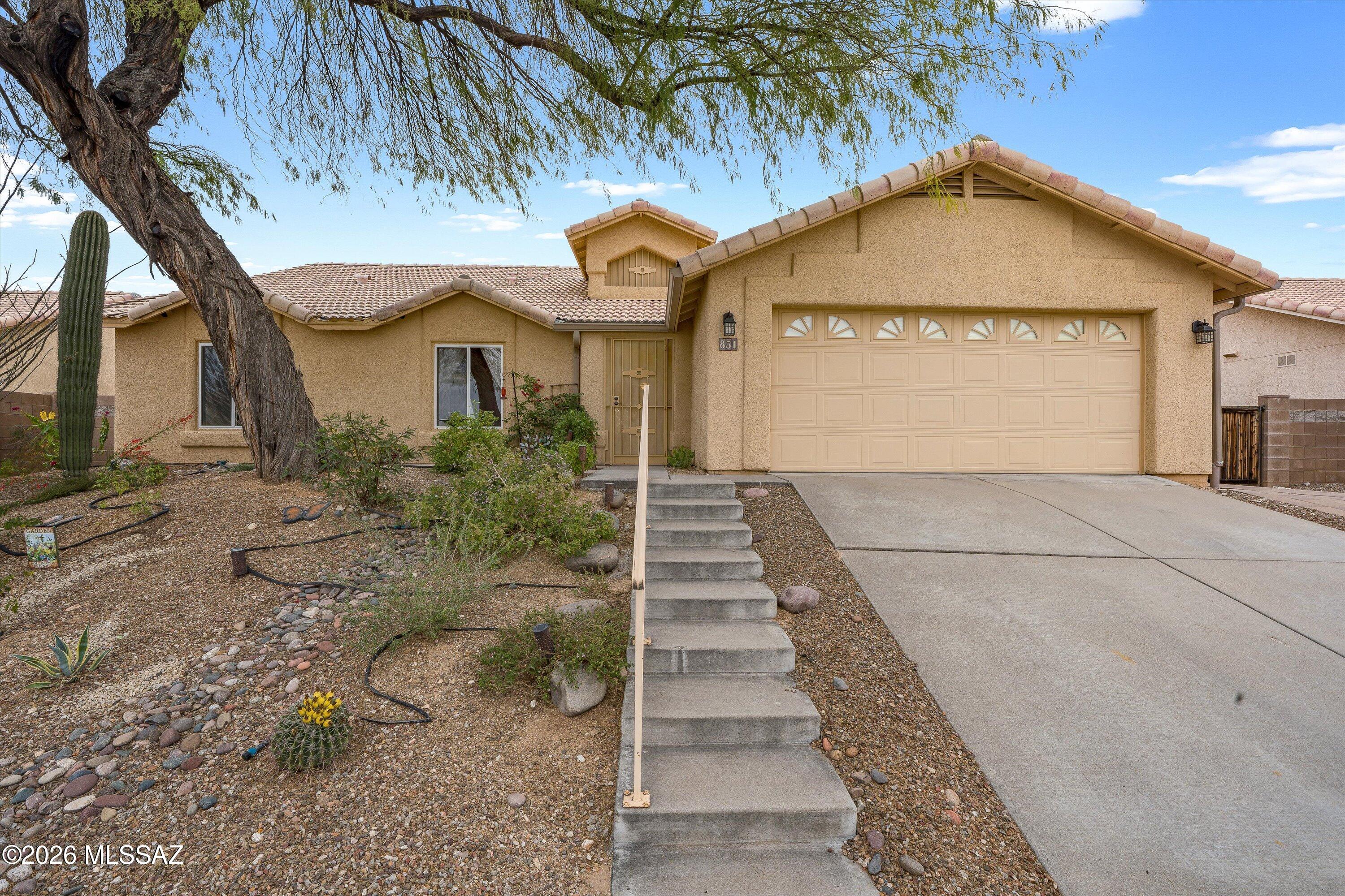 Backed by a natural common area with no rear neighbors, this beautifully maintained 4BR/2BA home offers privacy, Catalina and Rincon Mountain views. From the moment you step inside, you'll notice the rich engineered hardwood floors and inviting layout with split floor plan. The living room flows seamlessly into the dining area, while the spacious kitchen features newer cabinetry, butcher block countertops, stainless appliances, and opens to the comfortable family room, perfect for everyday living and entertaining.

The oversized primary suite includes a large walk-in closet and an updated bathroom with cultured granite countertops and an expansive walk-in shower with bench seating. Three additional bedrooms offer flexibility for families, guests, hobbies, or a home office, and the guest bath has been refreshed with cultured granite and a relaxing soaking tub.

Step outside to a backyard designed for gatherings, complete with a full-length covered patio that is east facing so you will have shade all afternoon, built-in BBQ with side burner, raised garden bed, and easy-care turf. A 2-car garage with overhead storage, plus a whole-house salt-free softener and water purification system, add even more value. Located in a popular neighborhood close to shopping, schools, and restaurants, this mountain-view home truly has it all.