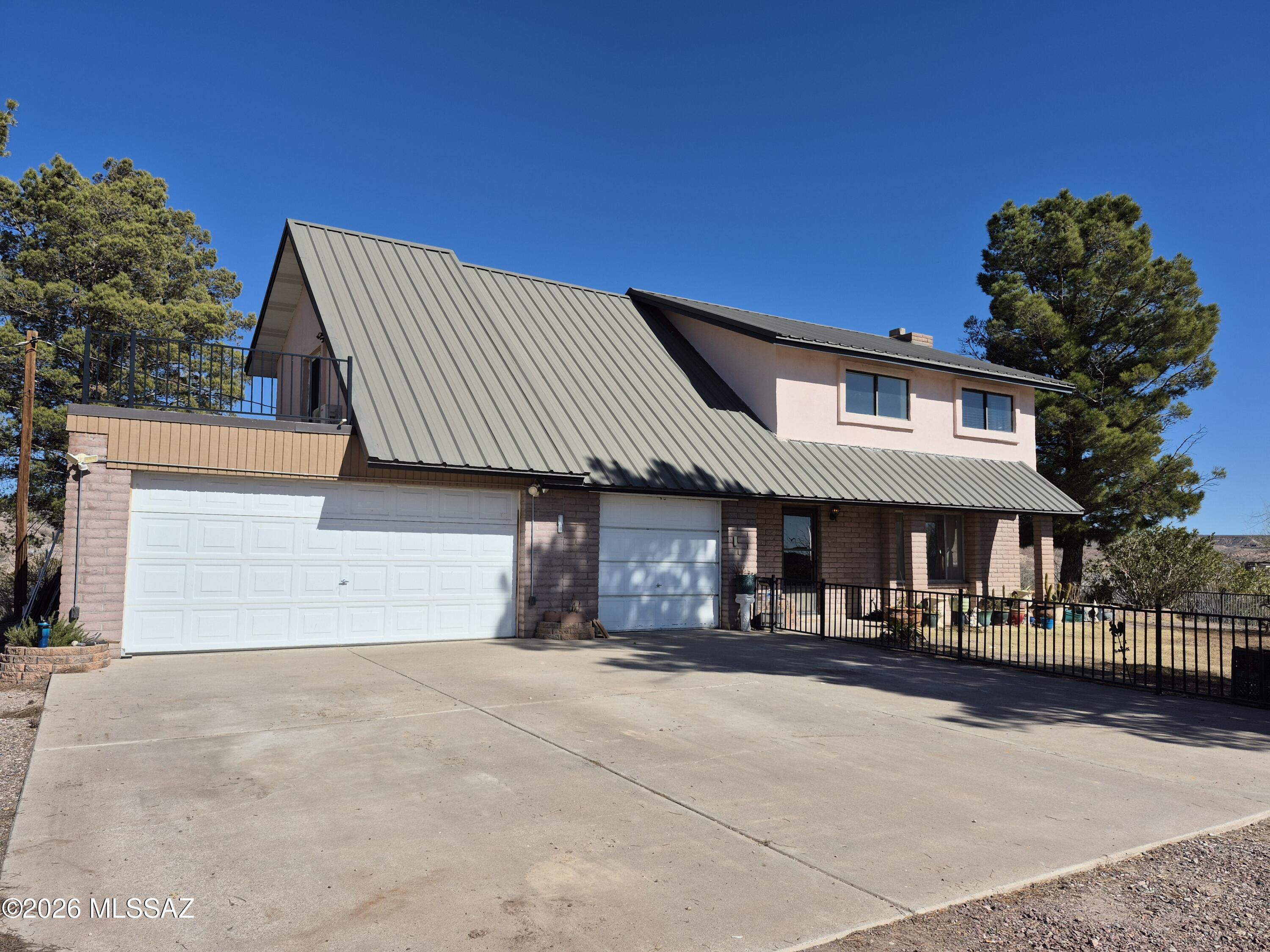 Horse Property with Spectacular Views! 
Enjoy panoramic views in every direction from this spacious 4BR, 2.5BA home with an attached 3-car garage. The main level offers multiple living areas perfect for relaxing or entertaining. All four bedrooms are located upstairs along with a full guest bath. The primary suite features two walk-in closets, a large vanity, and direct access to a west-facing balcony--ideal for sunset views.  
Outdoor living is a highlight here, with a porch or seating area on every side of the home, giving you endless options for enjoying the scenery. An additional 5-acre parcel to the north is also available, allowing you to expand to a total of 9.9 acres.