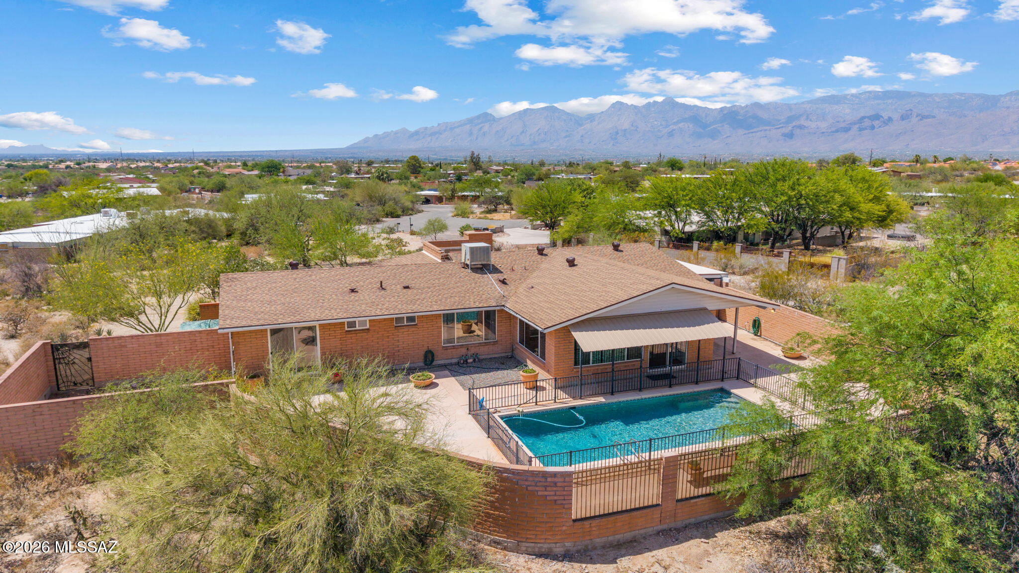 Experience the best of Tucson living in this beautiful ranch-style3-bedroom, 2-bath home perfectly positioned to capture stunning mountain views with no HOA. Set on a spacious lot, this property offers the privacy, flexibility, and outdoor lifestyle you've been looking for. Inside, you'll find warm and inviting living spaces highlighted by a cozy fireplace, abundant natural light, and a functional floor plan designed for everyday comfort and entertaining. Recent improvements include a brand-new roof and a beautifully refreshed pool with updated equipment, offering peace of mind for years to come. Step outside to your backyard retreat, where the sparkling pool, breathtaking mountain views, and generous outdoor space create the perfect setting for relaxing or hosting family and friends. The property also features a 2-car garage plus an attached carport/workshop area, providing ample room for vehicles, hobbies, storage, or recreational toys. Conveniently located near shopping, dining, hiking, and everyday amenities, this move-in-ready home combines thoughtful updates, incredible views, and the freedom of no HOA. Don't miss this rare opportunity to own a slice of the Sonoran Desert with endless possibilities.