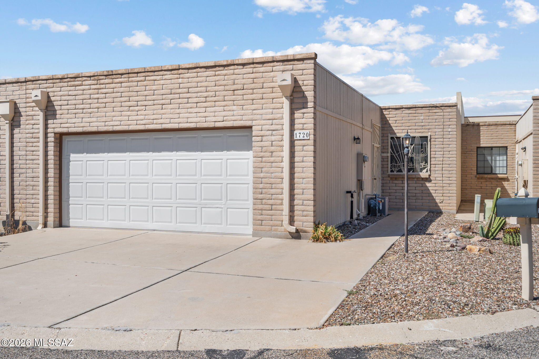 This beautifully maintained townhome offers the perfect blend of comfort, style, and low-maintenance living on Tucson's desirable east side. The primary bedroom is spacious with double closets, providing ample storage. Enjoy the convenience of double sinks in the primary bathroom plus, a built-in vanity in the bedroom. The heart of the home is the well-appointed kitchen, complete with painted cabinetry, ample counter space, and a stylish backsplash that adds a modern touch. The screened in patio includes a built-in kitchen and the low maintenance backyard has a few fruit trees. Additional highlights include tile flooring, vaulted ceilings, an attached two-car garage, and close access to the community pool for relaxing on warm days.