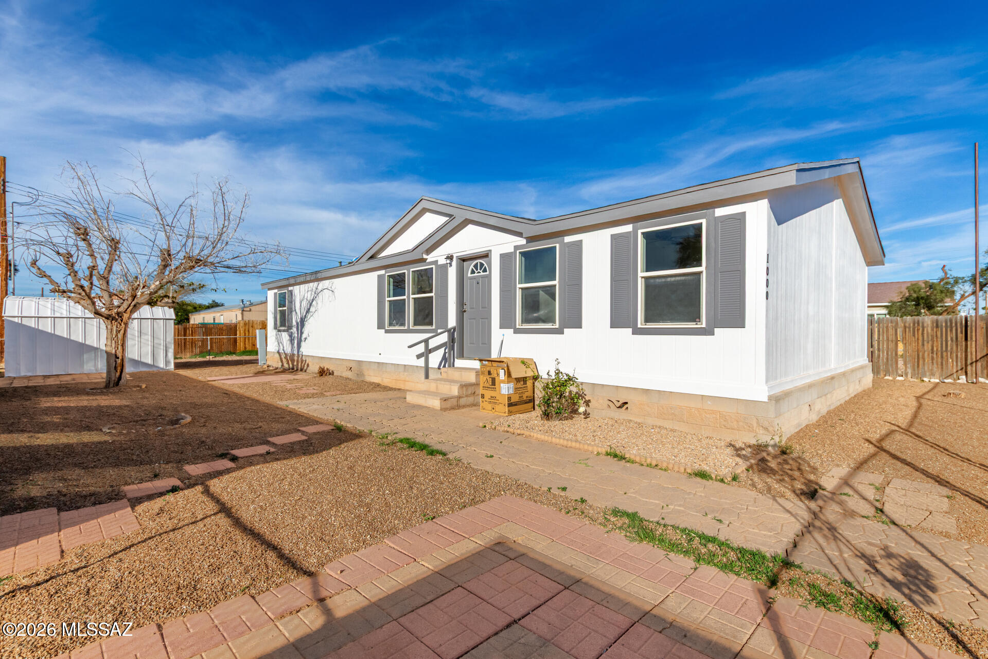 Beautifully renovated 3-bedroom, 2-bath manufactured home offering a bright open floor plan, vaulted ceilings, and flexible living space. Natural light fills the interior, highlighting fresh paint, ceiling fans, and a blend of wood-look and carpet flooring. The spacious kitchen features abundant cabinetry with crown molding, matching appliances, a center island, and ample counter space for cooking and entertaining. The primary suite provides a relaxing retreat with a private bathroom, separate shower, and soaking tub. A versatile den offers the perfect space for a home office, playroom, fitness room, or hobby area. Outside, enjoy a low-maintenance backyard complete with a covered patio and storage shed. Conveniently designed for comfortable everyday living. Owner/Agent.