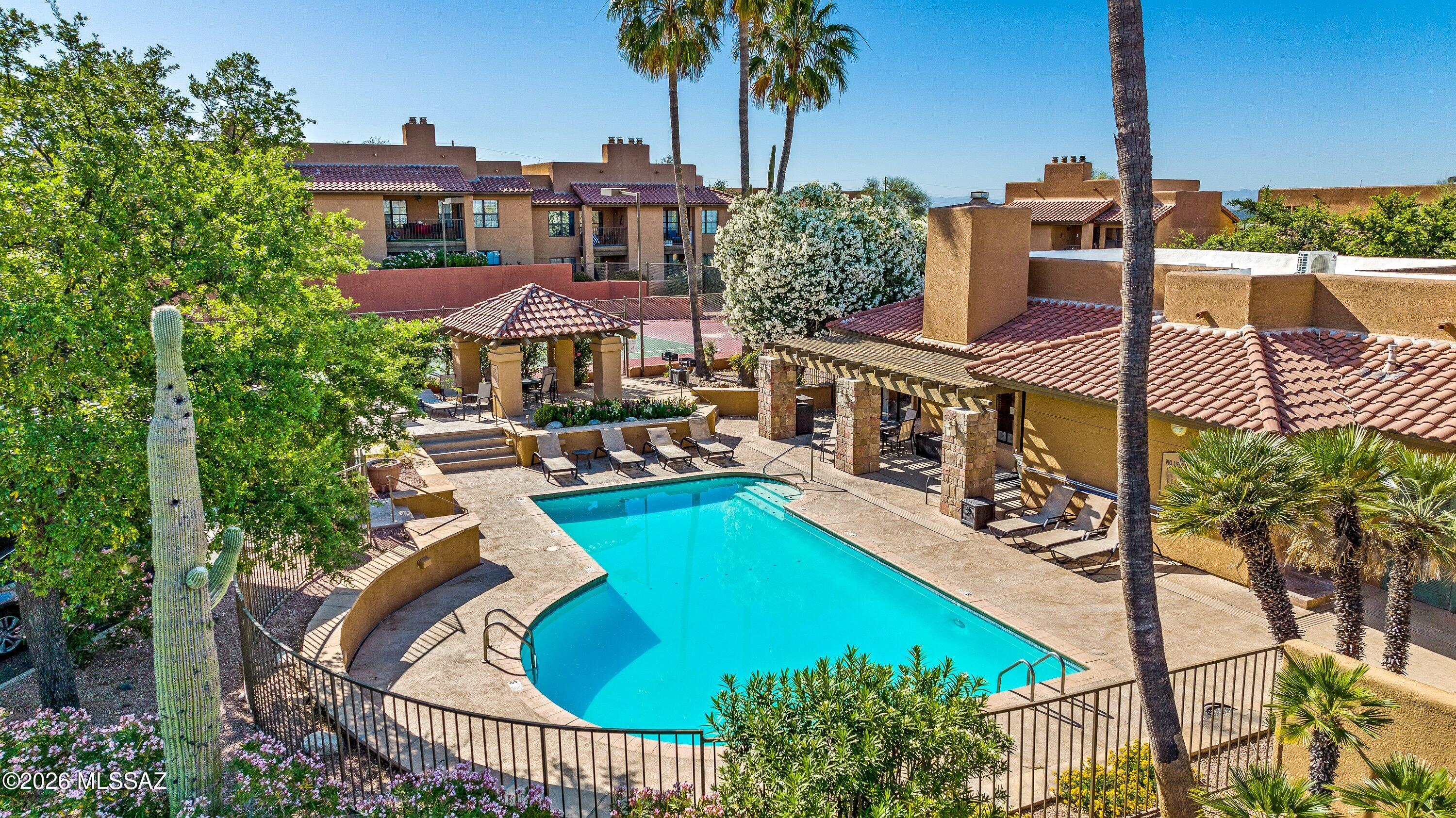 PRICED TO SELL! Skyline Village!  Awesome spacious foothills condo, located just north of La Encantada Mall, with inspiring views of the Catalina Mountains and lush desert. This unit features an open layout, with abundant natural light, wood burning fireplace, quartz countertops, private covered patio and a roomy primary bedroom with spacious closet. Freshly painted w/ new LG washer/dryer. The Skyline Village community features a heated pool and spa, exercise facility, tennis/pickle ball court, bbq grills and  tranquil fountains. Resort style living with easy access to shopping, numerous restaurants, hiking and world class golf. Vacation rentals allowed with restrictions. Next to La Encantada luxury mall- the meeting and shopping mecca of the foothills!