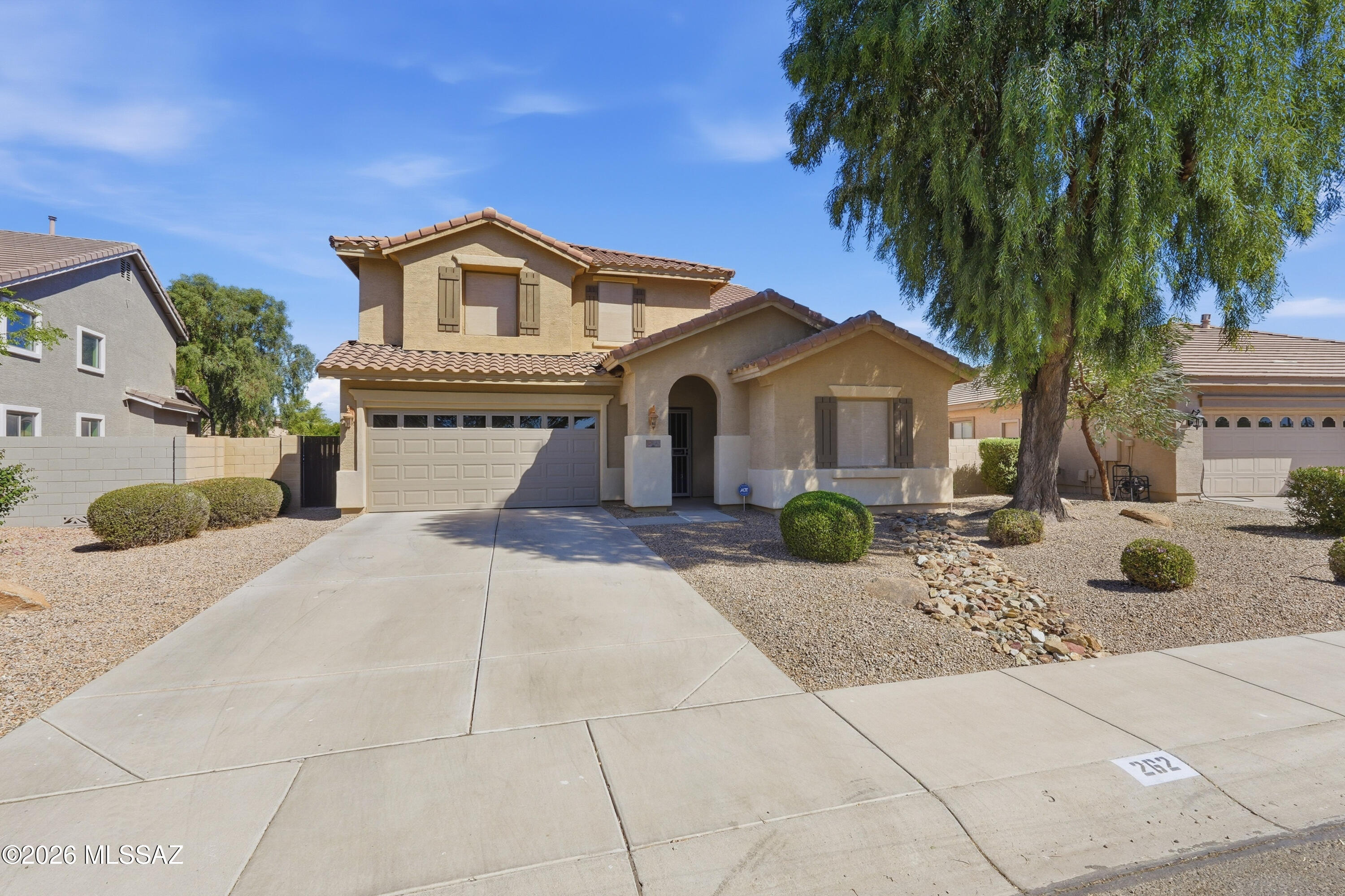Former model home on a lg lot w/ full bed & bath downstairs. The kitchen has engineer stone quartz countertops, travertine tile backsplash, walk-in pantry & refrigerator. Lg living room plus separate family rm w/ a travertine tile hearth around the fireplace. Upstairs, the lg primary suite offers a sitting area, dual walk-in closets, garden tub & walk-in shower. Laundry room has cabinets, a utility sink & washer/dryer. The 3 car tandem garage has Epoxy floors which were done in 2025. Fully landscaped extra large backyard big enough for a pool. Zoned A/C w/ one newer unit. New window screens installed in 2026. Whole house water conditioner system.  Across the street is the HOA's private waterpark & splash pad, as well as volleyball & basketball courts.