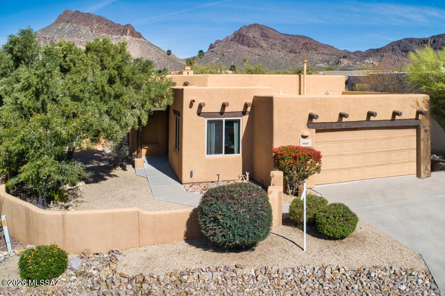 Located on a quiet cul-de-sac, this 3 bedroom 2 bath Herder home has all the Santa-Fe style characteristics! Large picture window in the living room with great mountain views. The covered back patio wraps around to the side for extra outdoor space. Newer water heater and roof is coated every few years. Murphy bed in a guest bedroom. Built-in shelving in closets. Utility sink in garage. Laundry room in hallway. Solid doors throughout home. Don't miss this quality home. Very active gated community with nice amenities including pool, spa, tennis, pickleball, bocce ball, and much more.