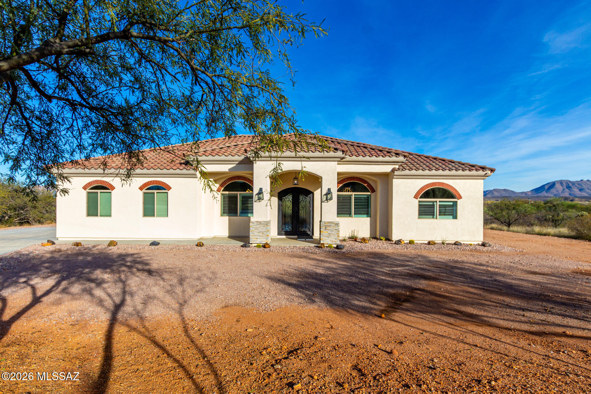 Beautiful, modern home just minutes from Tubac Golf Resort with wide-open views of the Santa Rita Mountains. Built in 2022, this turnkey home feels fresh, bright, and easy from the moment you arrive. The open-concept layout is perfect for everyday living and entertaining, featuring a spacious kitchen with a large island, modern cabinetry, and plantations shutters throughout for plenty of natural light. The living area is warm and welcoming with a stunning stone fireplace as the focal point. Enjoy peaceful mornings and colorful sunsets framed by big windows and mountain views. Clean lines, contemporary finishes, and a move-in-ready feel make this home the perfect blend of comfort and style in a beautiful Southern Arizona setting.