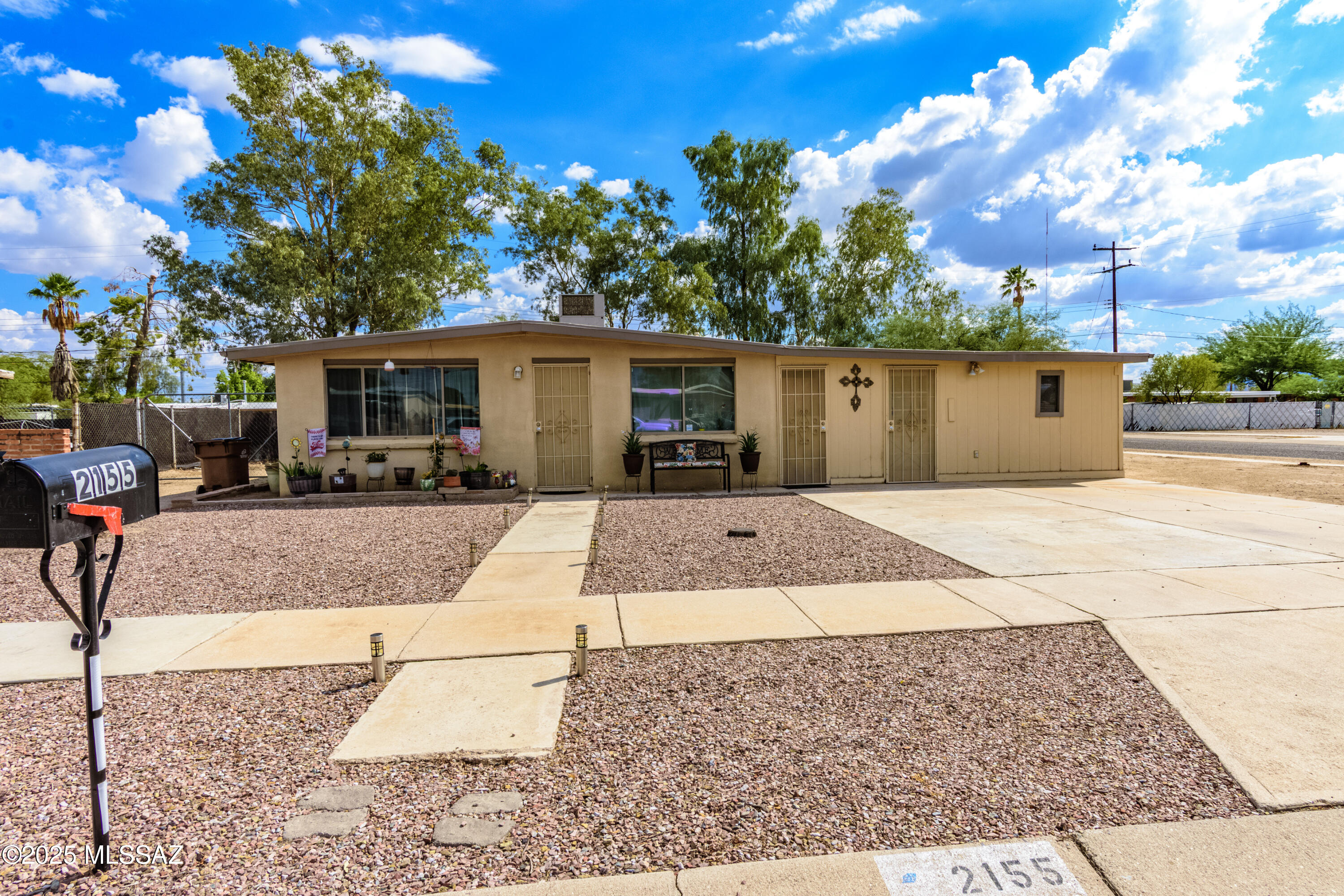 Discover the possibilities in this charming and well-cared-for home on a spacious corner lot, where No HOA means the freedom to truly make the property your own.

Inside, tile flooring runs through the main living areas--including the kitchen, living room, owner's suite, hallway, and bath--creating a clean and low-maintenance foundation for everyday living. Secondary bedrooms feature comfortable carpeting, while ceiling fans in every bedroom help keep the home cool and inviting.

The eat-in kitchen is both functional and welcoming, featuring classic oak cabinetry, expansive ceramic-tile countertops, ample storage, and all appliances included--perfect for casual meals or preparing your favorite dishes.

The bathrooms offer tasteful tile finishes, with the hall bath featuring a modern walk-in shower and storage cabinet, while the owner's suite includes a private vanity area and upgraded shower, creating a relaxing retreat at the end of the day.

One of the home's most exciting features is the enclosed approximately 680 sq ft garage/storage space, opening the door to endless possibilities. Whether you envision a workshop, home gym, creative studio, or hobby space, the flexibility here is hard to find (buyer to verify permits/use).

Outside, enjoy peaceful moments beneath the covered patio, along with the added convenience of a storage shed and covered work/storage area.

A rare combination of space, versatility, and practicality--this home is ready for its next chapter.