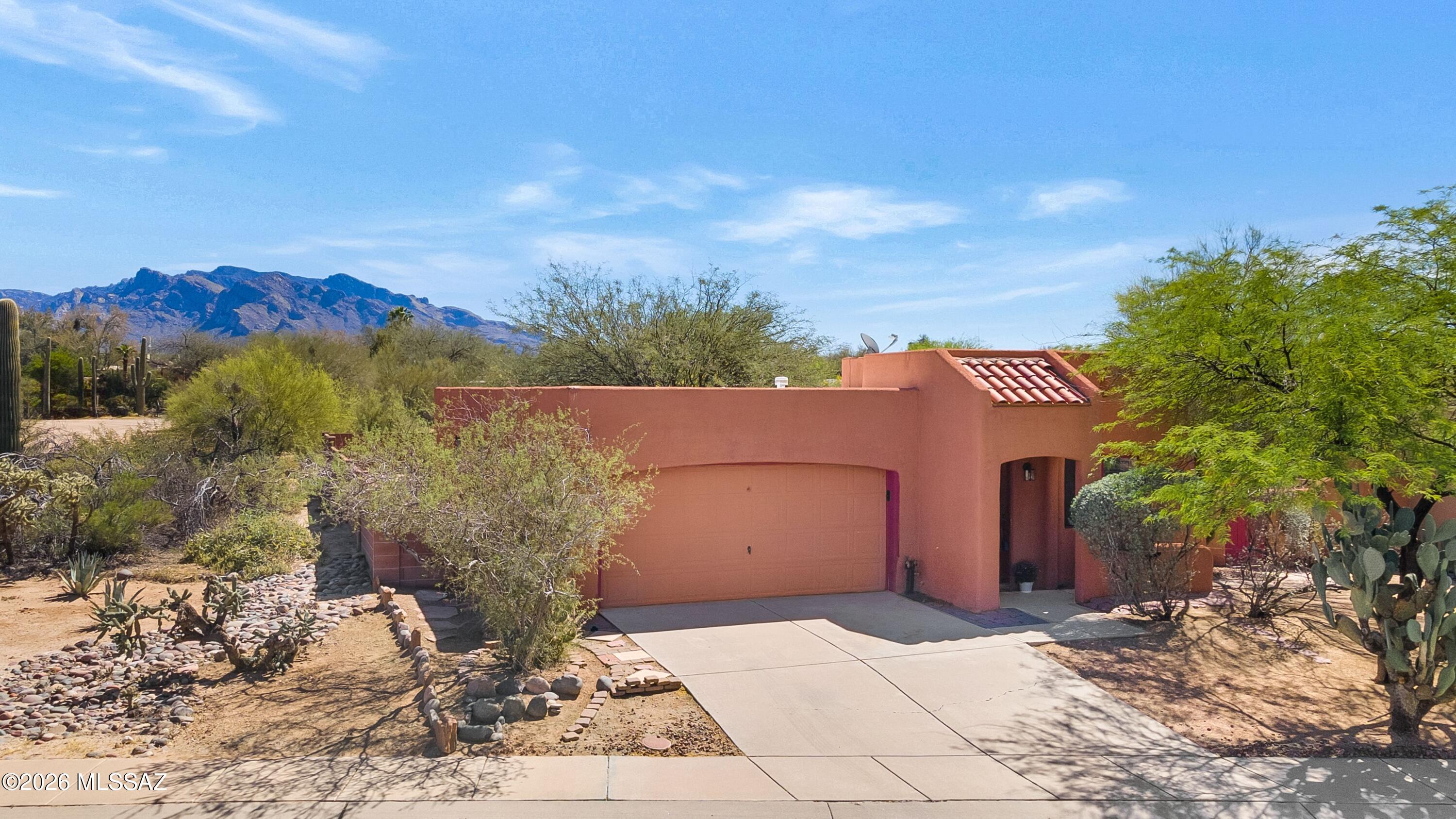 Tucked away at the end of a quiet cul-de-sac in the charming Ironwood Meadows enclave in Northwest Tucson. This 2-bed, 2-bath home with a den/flex space offers privacy, charm, and opportunity. The backyard is east-facing and home borders open space on two sides; the setting provides a peaceful desert backdrop with distant rear neighbors. Built by TJ Bednar, the home showcases classic Santa Fe elements. Though quaint in size, the home lives comfortably and offers flexibility for a variety of buyers: perfect for lock-and-leave, downsizing, or those entering the market. The den provides additional space for a home office, hobby room, or guest area.