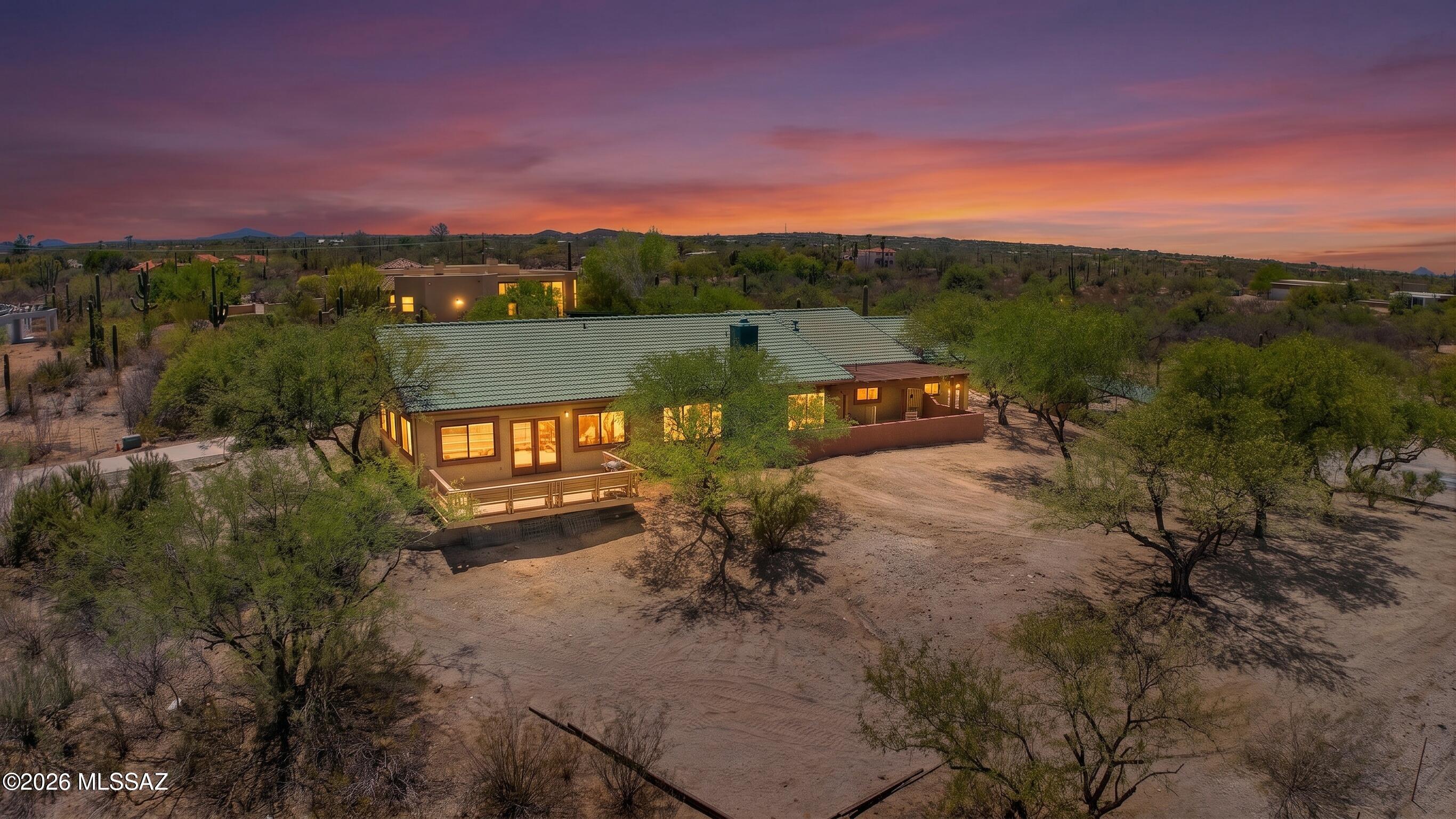 Tucked into a quiet gated setting, this 3.3 acre desert retreat captures panoramic Catalina and Rincon Mountain views from nearly every angle. Designed for flexibility, the split floor plan offers dual primary suites, creating ideal separation for guests or multi generational living. A spacious den easily functions as a home office or 4th bedroom. Expansive outdoor living invites you to take in vibrant sunsets and open skies, while the 6 car carport presents endless possibilities including horse facilities, workshop, or RV storage. Freshly epoxied floors. SELLER FINANCING WITH $200K DOWN. This is space, privacy, and lifestyle all in one. A six car carport, formerly configured as horse stalls and a barn, provides exceptional versatility and could easily be converted back for equestrian use. Convenient location in the Tanque Verde Valley just 10 minutes to grocery stores, restaurants, bars, cafes, & more. Get to Summerhaven at the top of Mt. Lemmon in less than an hour for cooler temperatures in the summer or to play in the snow in the winter. Access to endless hiking, biking, and horseback riding trails in the Catalina and Rincon mountains. Play golf at 49ers Country Club or the acclaimed Arizona National Golf Course just 10 minutes away. La Mariposa Fitness & Sports Club features tennis/Pickleball Courts, workout facilities, a junior Olympic-sized swimming pool, and a variety of fitness classes. Area schools include the highly-rated Tanque Verde School District, This home is located in the highly-rated Tanque Verde School District, which consists of a Tanque Verde (TV) pre-school, Agua Caliente & TV Elementary School, Emily Gray Jr. High School, and TV High School.
Hermosa Montessori School, Leman Academy of Excellence Charter School, Basis Charter, The Gregory School, St. Michael's, St. Cyril's, Desert Christian K-12, the La Paloma Academy, and more.

49ers Country Club:
49ers Country Club is a semi-private club designed by William Francis Bell. Spread over 110 acres, the course is known for its lush, mature landscaping and excellent course conditioning. Members enjoy a 6,681-yard, 18-hole, par 72 golf course. The winding fairways and majestic mountain views surprise golfers at every turn.
The Rincon Mountain Grill, a full-service restaurant open to the public, serves breakfast, lunch, and dinner. Forty Niners CC offers a swim team, summer camps, and several events throughout the year, including holiday parades and other special events. The new fitness training facility is fully equipped gym and offers fitness class.


Mount Lemmon:
Just an hour away, Mount Lemmon is the highest point in the Santa Catalina Mountains, topping out at more than 9,000 feet. Visit this mountain retreat to cool off in the warmer months and to enjoy a snowy playground in winter. Top cyclists from around the world come here to train on one of the best tests of climbing and descending in the country. There are trails for hiking and biking all over the mountain, and over 2500 rock climbing routes to choose from.