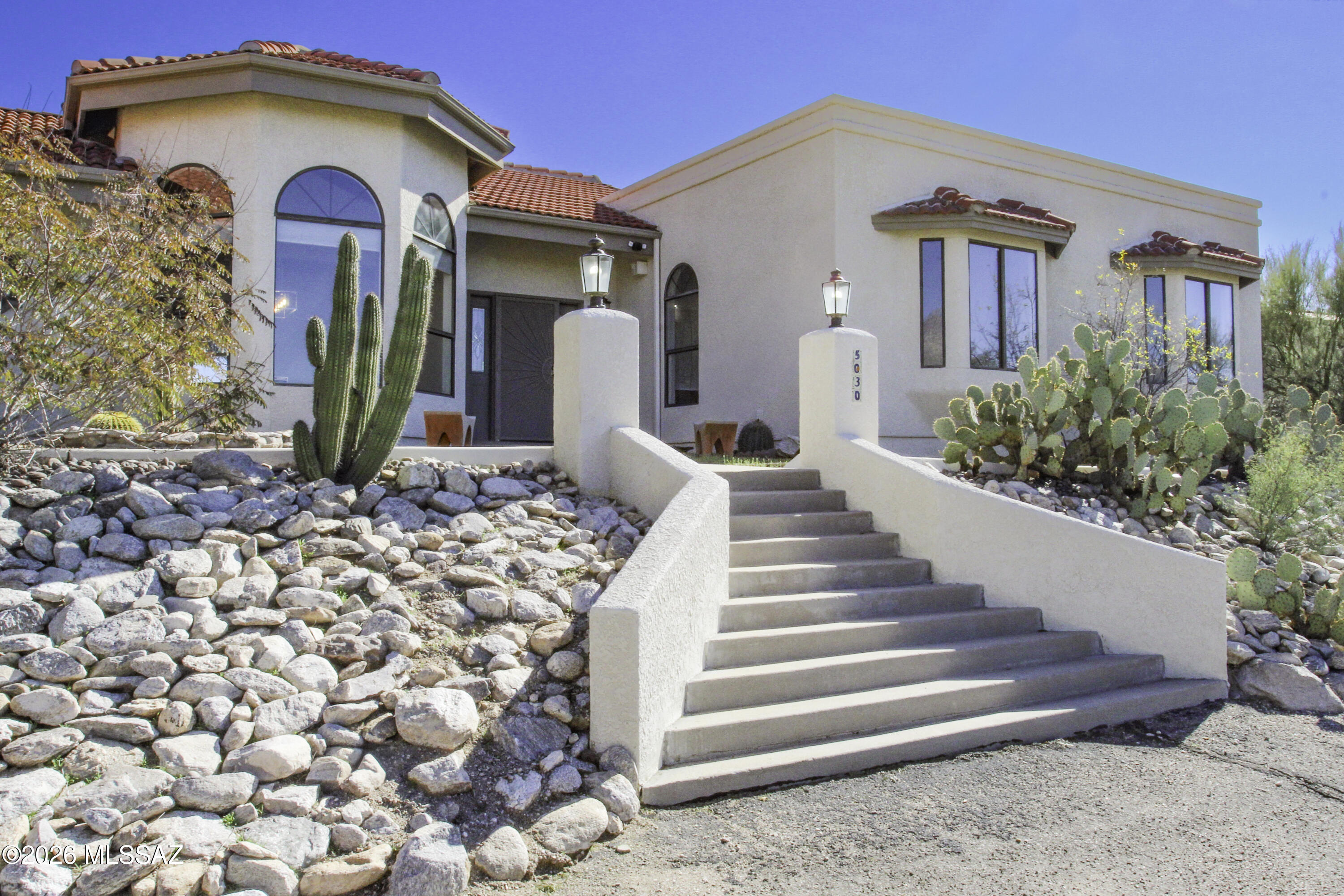 Range Price: $990,000-$1,075,000. Seller to review offers within the listed price range.
Perched on a ridge top in the prestigious Tucson Catalina Foothills, this stunning 4-bedroom, 3-full-bath home offers exceptional privacy and breathtaking city and mountain views. Thoughtfully designed, the home features a private den/study ideal for a home office or quiet retreat. The open-concept kitchen flows seamlessly into the main living areas, perfect for both everyday living and entertaining, while a formal dining room adds an elegant touch for special gatherings. Step outside to a beautifully landscaped, oversized backyard complete with lush grass, a sparkling pool, and relaxing jacuzzi—your own private oasis with panoramic vistas.