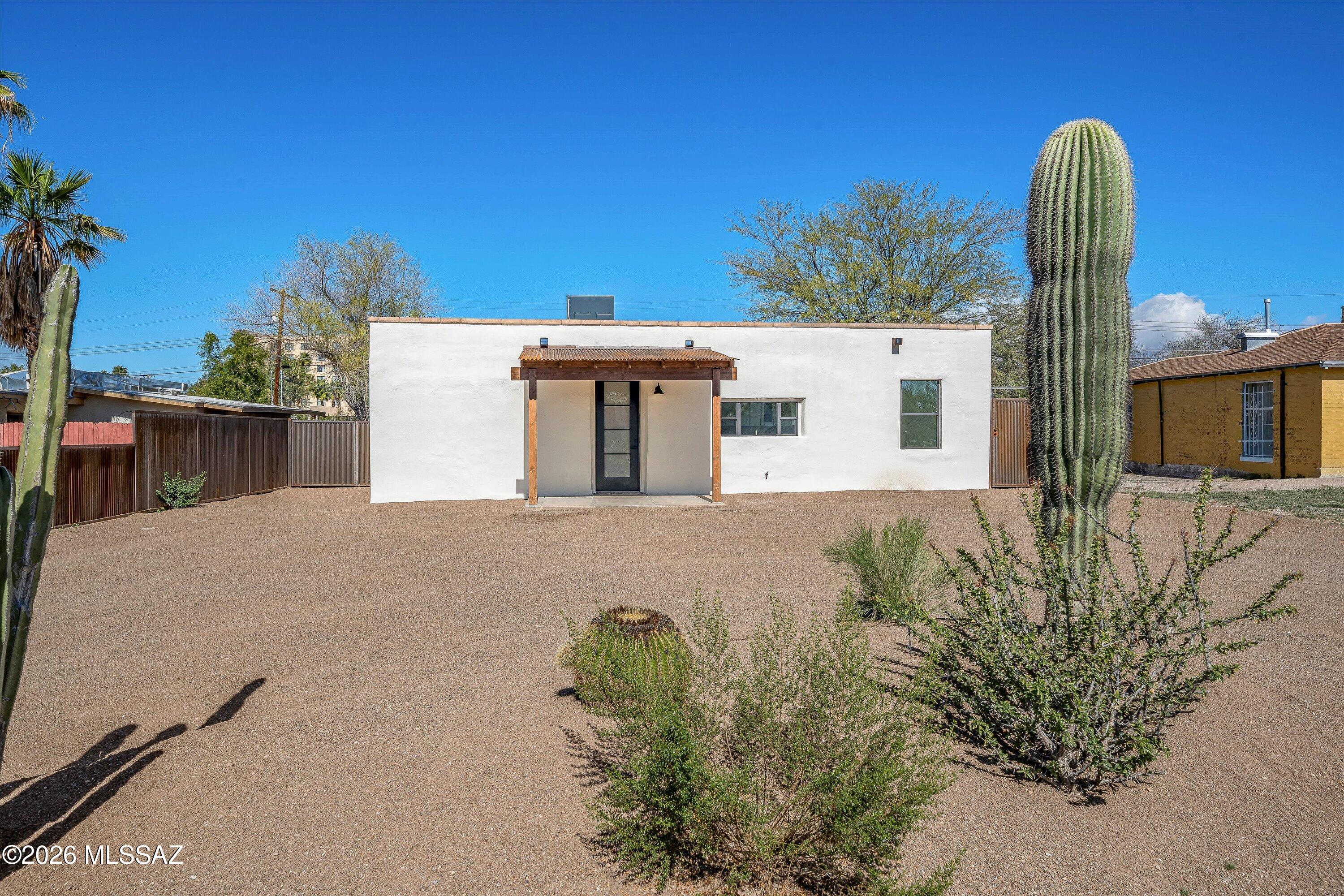 Centrally located, newly renovated 1942 mud adobe with new addition in San Gabriel Neighborhood! This beautiful home has been thoughtfully rebuilt in keeping the existing rich history combined with new modern touches throughout. Showcasing its historical charm with an exposed yet timeless smooth finished mud adobe feature wall. You'll appreciate all new flooring, new kitchen remodel with 42in upper/soft close cabinetry, high ceilings & two owner suites! The all-new addition of the home includes an expanded comfortable primary owner suite. Stunning new bathrooms, walk-in showers, all new doors, fixtures, ceiling fans & most importantly - all new plumbing & electrical panel/system throughout. New sewer line to the property line, new water line to the home, all new roof, new HVA drywall & fresh interior paint. Exterior doesn't fall short with all new stucco, new ext. paint, all new front & back corrugated covered porches with concrete slabs, all new corrugated metal fencing with entry gate & a spacious backyard ready to make your own! Zoning allows for ADU. **Seller to install, at seller's preference & expense, stainless-steel appliances: refrigerator, OTR microwave, electric range & dishwasher. Workmanship warranties transfer, zero cost.
