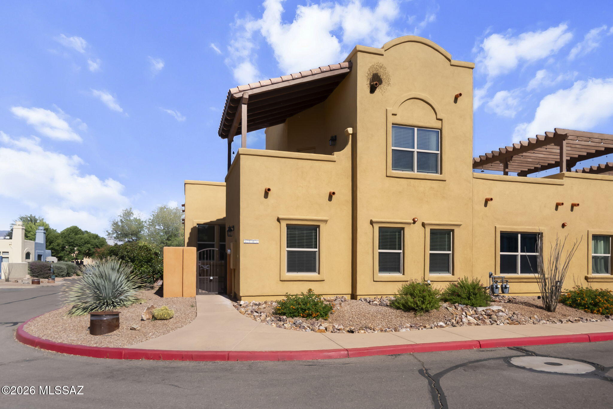 Welcome to easy living in the charming community of Barrio Embarcadero at Tubac. This beautifully maintained corner unit townhome offers the perfect blend of comfort, convenience, and low maintenance living. Ideal for seasonal residents or those ready to enjoy a more relaxed pace year round. Built in 2020 and lightly lived in, this 3 bedroom, 2 bath home feels practically brand new. With 1,563 square feet of thoughtfully designed space, you'll appreciate the bright, airy feel created by abundant natural light and an open-concept living and dining area. A cozy gas fireplace adds warmth and charm perfect for cool desert evenings. The spacious kitchen is both stylish and functional, featuring granite countertops, a large island with bar seating, stainless steel appliances, a pantry, and soft-close cabinetry. Each bedroom is generously sized, offering flexibility for guests, hobbies, or a home office. Upstairs, the private primary suite serves as a peaceful retreat, complete with a large walk-in closet, dual vanities, ample linen storage, and your own exterior balcony perfect for enjoying Arizona's beautiful sunrises and sunsets. The HOA enhances your lifestyle with access to a pool, hot tub, and recreational room great for socializing or unwinding. Conveniently located just minutes from local dining, golf course, pickleball courts, and everyday essentials, this home offers the best of both relaxation and accessibility. Whether you're seeking a seasonal getaway or a full time residence, this is truly a lock and leave property designed for comfort and ease.