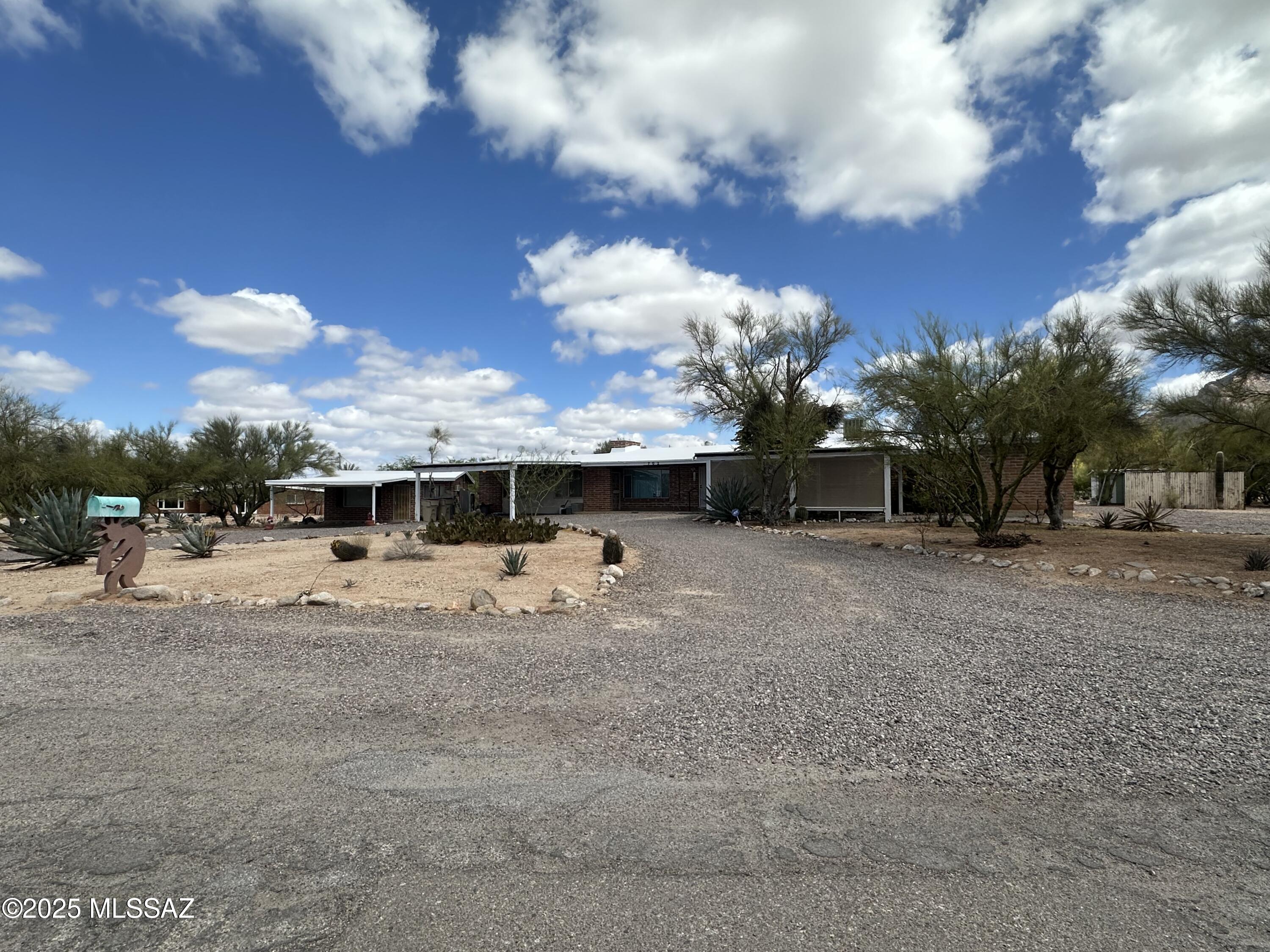 Located in a quiet neighborhood conveniently nestled behind the Casas Adobes shopping center, this classic adobe home and separate casita sit on just over an acre lot, include covered parking, no HOA, enclosed backyard, all while being close to shopping, dining, and medical care.