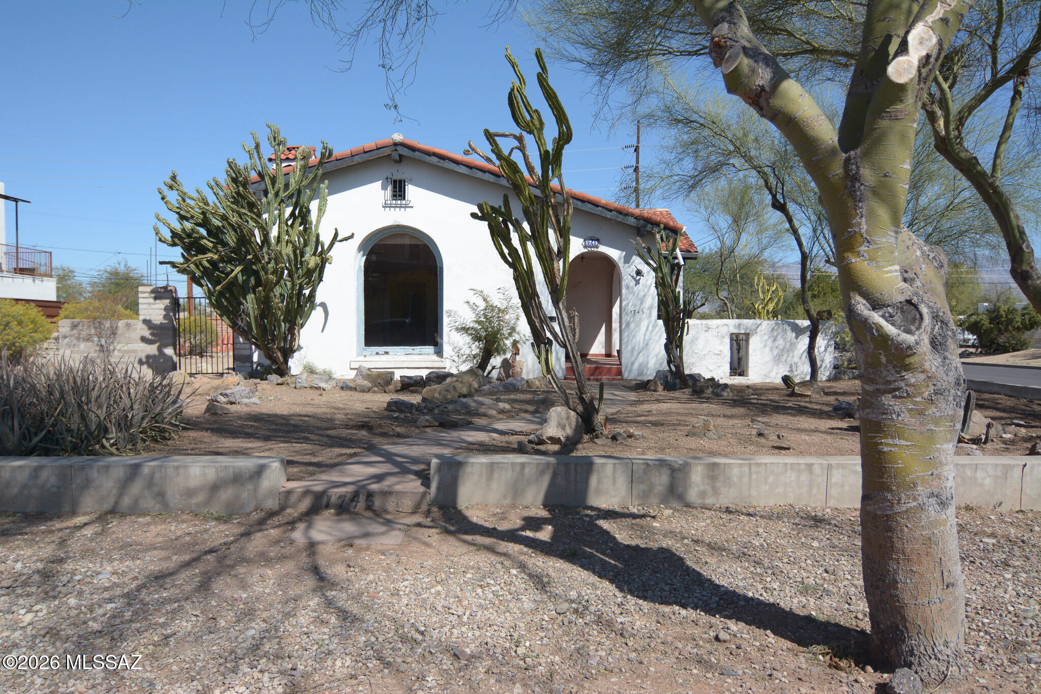 Great investment!  The home has tons of charm, a fireplace, and wood floors.  Needs TLC. The front house has 2 bedrooms and 1 bath, and the guest house has 1 bedroom and 1 bath.  Corner lot. Cash only.