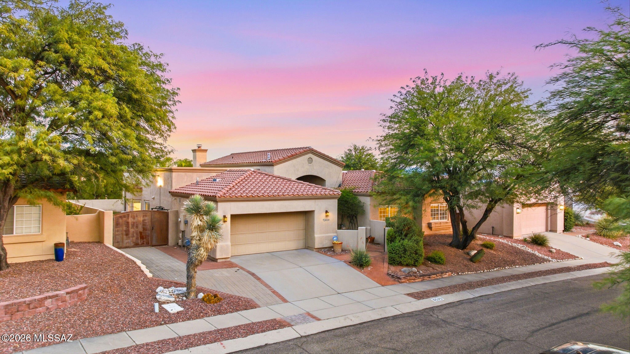 Stunning curb appeal, soaring ceilings, and a truly standout kitchen define this beautifully cared-for home in a prime Catalina Foothills setting! Nestled within a charming neighborhood, the residence pairs distinctive architectural character with modern amenities and exceptional pride of ownership! Mature landscaping and a welcoming brick walkway set the tone, while graceful arches, statement columns, and abundant natural light create an impressive arrival. Generous proportions and beautifully connected living spaces make the home feel even larger than its square footage suggests!
The gourmet kitchen is the centerpiece, featuring a Sub-Zero refrigerator, six-burner gas cooktop, double wall ovens, wine refrigerator, and stainless-steel appliances. Rich cabinetry, granite countertops, a a center island, and an inviting breakfast bar bring together style, storage, and everyday functionality. Opening to a casual dining area and comfortable family room anchored by a stacked-stone gas fireplace, this is a space equally suited to quiet mornings and lively gatherings! Separate living and dining areas offer additional room to entertain without sacrificing the home's warm, welcoming feel.
The expansive primary suite provides a relaxing retreat with room for a sitting area and a beautifully appointed bathroom featuring dual vanities, a soaking tub, an oversized glass-enclosed shower with a bench, and a spacious walk-in closet!
Outside, a deep covered patio invites lingering dinners and shaded afternoons beside the sparkling pool and rock water feature. Brick-paved outdoor spaces, a separate turf area, and established landscaping create a backyard with room to gather, unwind, and enjoy the mountain views!
A rare combination of prime Foothills location, impressive living spaces, and thoughtful updates--offering the character of an established neighborhood with the comfort and amenities of a beautifully maintained home!