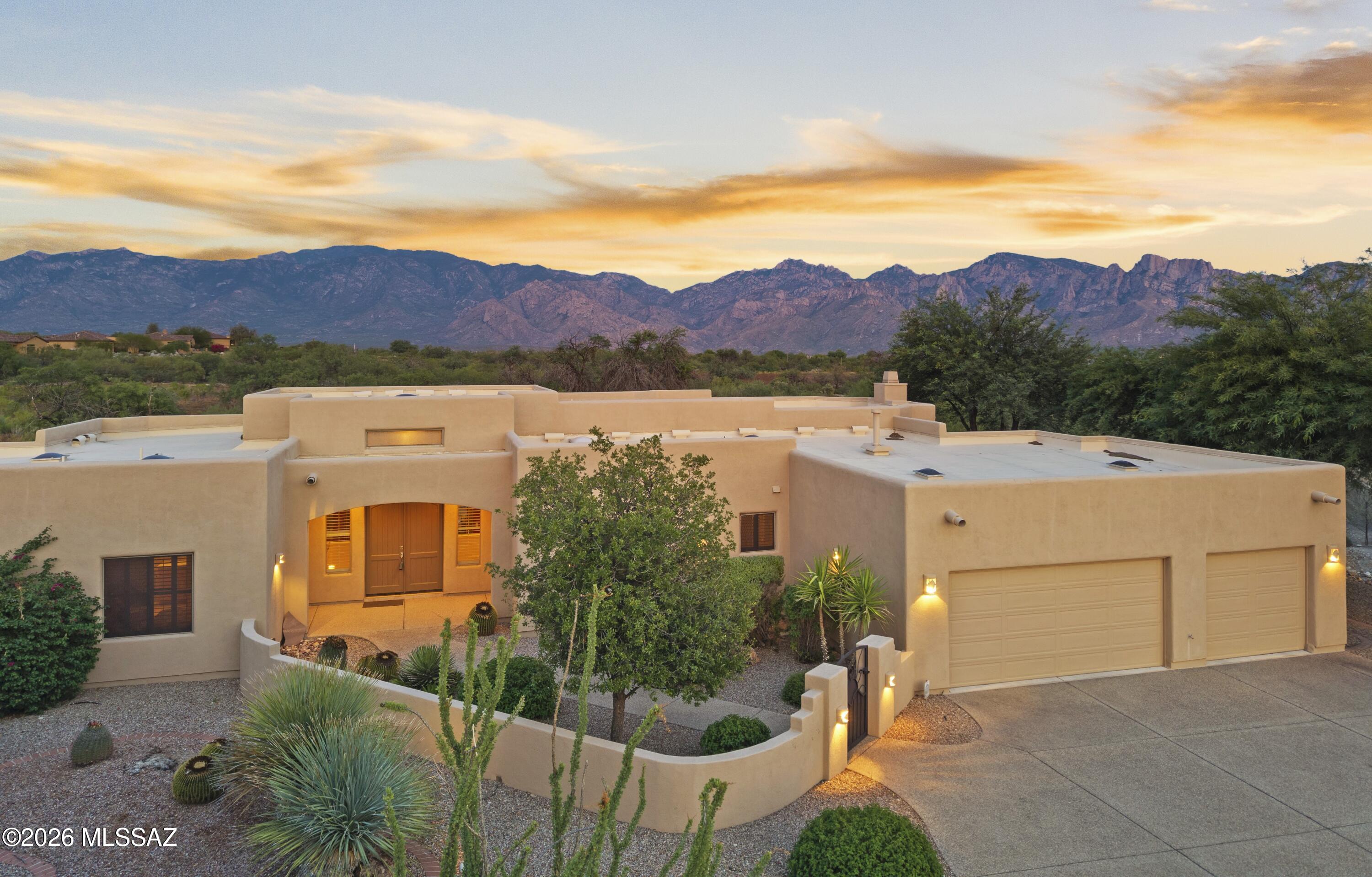 Located in Oro Valley in one of Rancho Vistoso's most sought-after gated communities, this exceptional 3,240sf single-story 3BR/3BA+den home offers unobstructed Catalina Mountain views, a resort-style backyard with pool and spa, a desirable split-bedroom floor plan, and an oversized three-car garage. Combining location, views, privacy, and livability, this home checks all the boxes. A gated courtyard leads to an impressive entry into an elegant interior where soaring ceilings, abundant natural light, warm architectural details and expansive living spaces create an inviting atmosphere. The spacious family room has a dramatic wood-beamed ceiling, custom-built-ins, a beautiful stone fireplace, and seamless access to the outdoor living areas. The heart of the home is the generously sized kitchen, thoughtfully designed with abundant cabinetry, granite countertops, center island, breakfast bar, built-in appliances, planning desk and breakfast nook all perfectly positioned to capture views of the backyard and mountains beyond. The private primary suite is a true retreat featuring a spacious sitting area, large picture windows overlooking the backyard, luxurious bath with dual vanities, soaking tub, oversized walk-in shower and 2 generous walk-in closets. Separate guest bedrooms provide privacy for family and visitors, while the dedicated den offers the perfect space for home office, library, or hobby room. The backyard feels like your own private resort with an expansive covered patio overlooking a sparkling pool and elevated spa, all set against a spectacular backdrop of the Catalina Mountains. With no immediate neighbors behind, this tranquil setting offers exceptional privacy while providing the perfect space for outdoor dining, entertaining, or simply quietly relaxing. Additional highlights include plantation shutters, custom finishes throughout, spacious laundry room with extensive cabinetry and utility sink, oversized three-car garage with abundant storage and meticulously maintained low-care landscaping. Located near Stone Canyon w/optional golf & social memberships, this home blends luxury, nature & exclusivity. Enjoy easy access to Oro Valley's premier 6.2-mile Vistoso Trails path. Minutes to shopping, dining, theaters, hiking, biking & medical. Combining an exceptional location, spectacular mountain views, outstanding privacy, resort-style outdoor living, and timeless quality, 560 W. Quiet Springs Drive presents a rare opportunity to enjoy the very best of Oro Valley living. This is Arizona luxury at its finest.