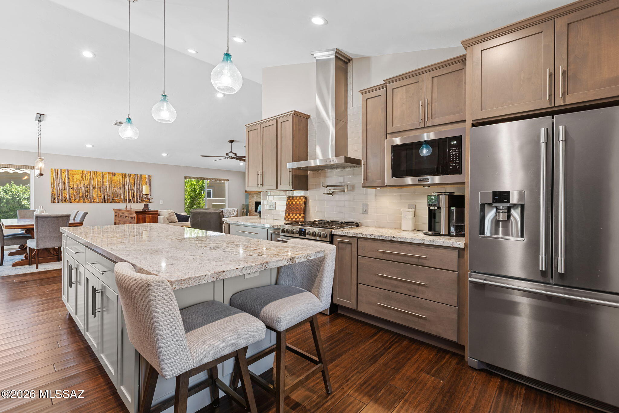 Beautifully renovated 3BR/2BA Oro Valley home featuring a 2019 remodel with designer kitchen, granite countertops, Frigidaire Professional Series appliances, two wine refrigerators, bamboo flooring, remodeled baths, and custom gas fireplace. Backyard oasis offers Catalina Mountain views, Pebble Tec pool, travertine patio, pool solar, built-in BBQ, Big Green Egg, and outdoor gas fireplace. Additional upgrades include new roof (2022), owned solar (2023) with average electric bills around $30/month, new windows (2021), new HVAC, updated pool equipment, and custom primary closet shelving. A rare combination of luxury, efficiency, and exceptional indoor-outdoor living.