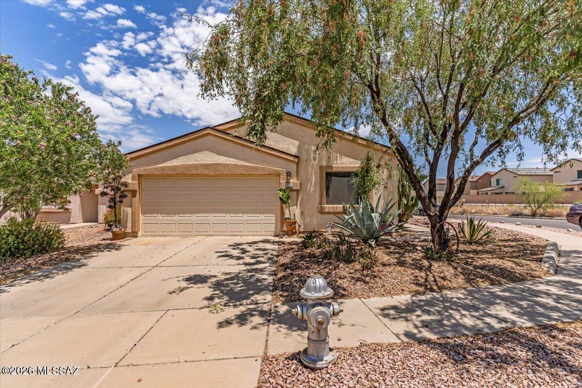 Corner lot, pool with slide and steps away from The Loop. Located in the highly rated Vail School District and a few minute walk to Mesquite Elementary School.  This well-cared for home offers an updated kitchen with quartz counters and stainless steel appliances, no  carpet, remodeled bathrooms and roof replaced in 2022. The backyard is perfect for entertaining with a sparkling pool with newer slide, artificial turf and plenty of room to enjoy Tucson's sunshine.  The backyard has lemon and lime tree.  Close to shopping, dining and medical facilities.  This is a great place to call home.
