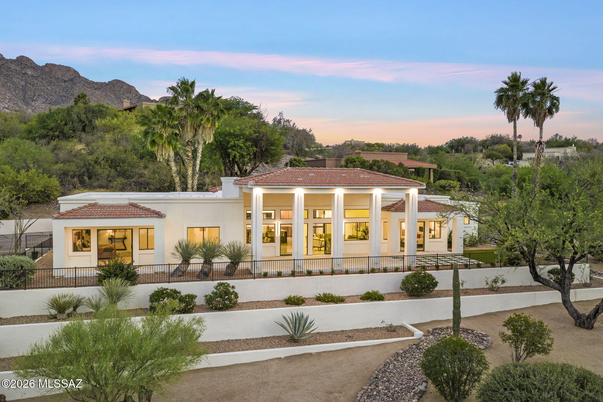 Majestic Oro Valley Country Club Home Perched high on a premium elevated corner lot overlooking the stunning 18th lake hole of Oro Valley Country Club, this fully remodeled masterpiece redefines luxury desert living. With 5 bedrooms, 5 bathrooms, and a large detached guesthouse, this estate offers an exceptional blend of sophistication, space, and versatility.
Step inside to experience a home that has been completely transformed with high-end designer finishes throughout. The heart of the home is a chef's dream kitchen, featuring top-of-the-line Thermador appliances, striking quartzite countertops, custom cabinetry, and expansive prep and entertaining space. Towering ceilings and walls of windows flood the home with natural light while perfectly framing the