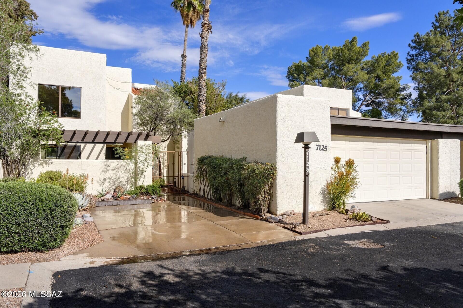 High Ceilings, Open Floor Plan and Lots of Natural Light.  Crisp, Clean Contemporary Design, all Neutral Decor.  Move-in ready, Freshly Painted and New Carpet.  Enter through a Charming Courtyard into Gracious Living Space.  Eat-in Kitchen with easy access to Brick Patio and Private Backyard. Split Bedroom Plan offers a Secluded Master Suite and two spacious Guest Bedrooms, both with Patio Access.  Detached Garage with Extra Storage plus a separate front Parking Pad.  Handsome Architecture in a Park-like Setting. Great Location, Close to Sabino Canyon, Restaurants and Shopping.  Wonderful HOA Amenities:  2 Community Pools, Spa and Tennis Courts.