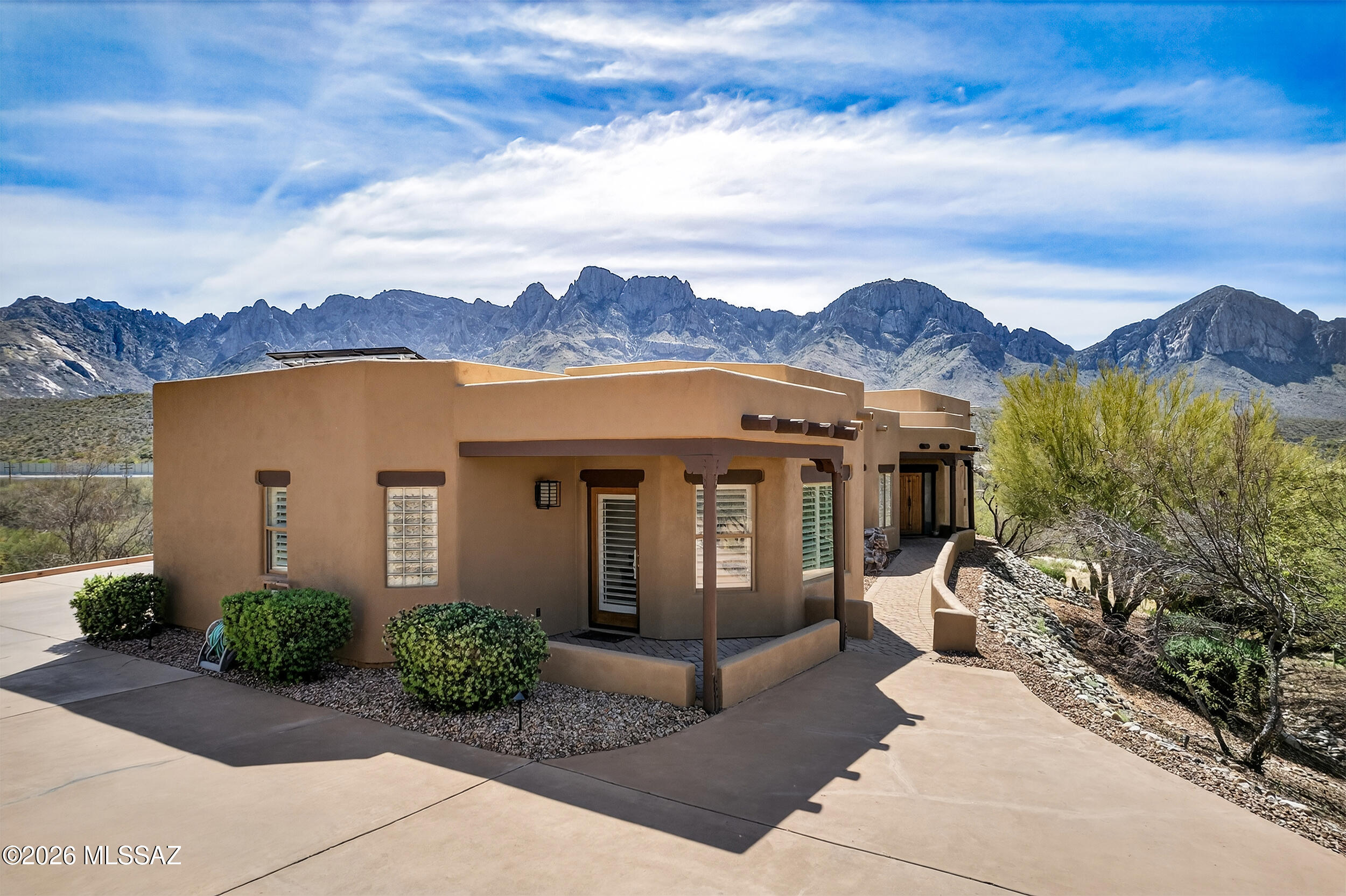 Stunning hilltop cul-d-sac residence located in the gated enclave of Palisades Point Estates, offering sweeping panoramic views of Pusch Ridge and the Catalina Mountains. This thoughtfully upgraded 3-bedroom home plus office features 3 baths and an open, elegant design with cherry cabinetry, granite countertops, stainless steel appliances, double ovens, Lutron lighting and automated shade controls, heated floors and towel racks. The resort-style backyard is a true sanctuary, complete with sparkling pool and spa, covered ramada, built-in BBQ, and unobstructed mountain vistas ideal for entertaining or relaxing. Additional upgrades include owned solar, new HVAC system, new water heater, freshly coated roof, and fresh interior and exterior paint. A rare opportunity to enjoy luxury, comfort, and unforgettable views in a premier Oro Valley location.