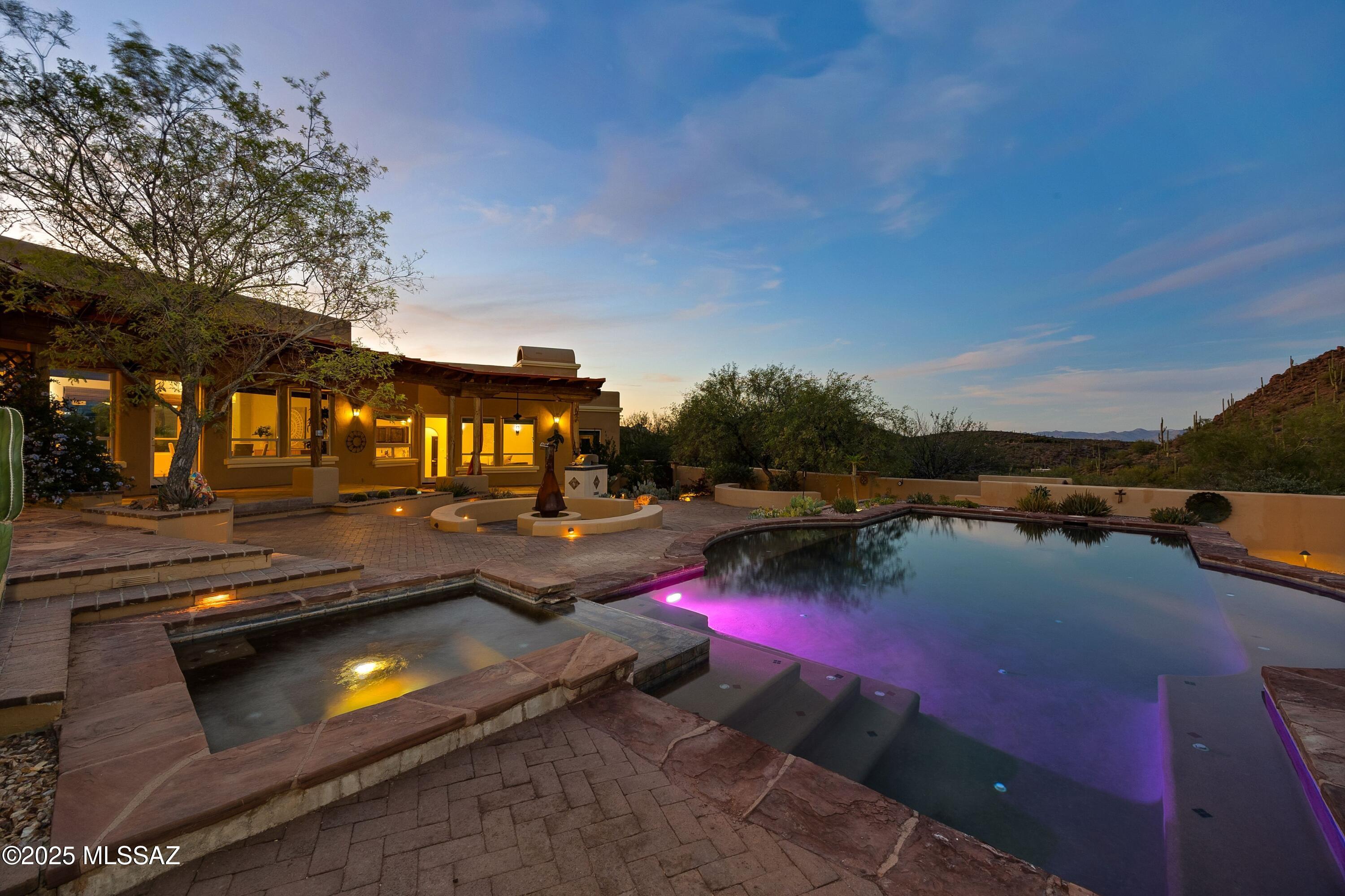 Perched high on a hilltop in the Tucson Mountains, 6539 W El Camino Del Cerro showcases the majesty of the desert in every direction. Sitting on nearly 4 acres behind a double gated entry, there is space and privacy, with quick access to trails. While the setting is casually elegant, there is no HOA. 

The property includes a custom home with attached 3-car garage, a detached oversized garage, outdoor amenities, and a walking path. Despite being in the mountains, this parcel has the benefit of city water and paved road access. Designed for comfortable and easy living, the 2,820 sq ft residence offers a split floor plan with 4 bedrooms, 2 ½ bathrooms and 2 living/dining spaces. Throughout, there are concrete floors and large windows offering incredible views. From morning to evening, the changing light exposes different layers of desert beauty. During a recent renovation, the kitchen has been upgraded with solid alder cabinetry and luxury granite slabs, creating striking contrast.

Facing east, and oriented towards the Catalina Mountains, the expansive backyard is an extension of the home. Take in morning light at sunrise, pink mountains at sunset and twinkling lights after dark. With a custom swimming pool & spa, covered patio and tiers of hardscape for multiple seating zones, there are many opportunities for gathering or quiet moments. 

Facing west, the front of the home faces the Tucson Mountains and Saguaro National Park. This exposure captures colorful sunsets, which are easily enjoyed from the dining areas or front courtyard.

Built in 2022, the detached garage or workshop is 23' x 29' and includes electrical and oversized 10' doors for easy access.  The interior height would easily accommodate an auto lift. Use possibilities here are many.

Living here, the Tucson Mountains are your playground. With the El Camino Del Cerro Trailhead and Sweetwater Preserve right around the corner, opportunities for hiking, trail running, mountain biking and horseback riding are abundant. Though this setting feels away from it all, city amenities are incredibly accessible - driving to Costco & other shopping is 15 minutes and traveling to Downtown Tucson is 19 minutes.