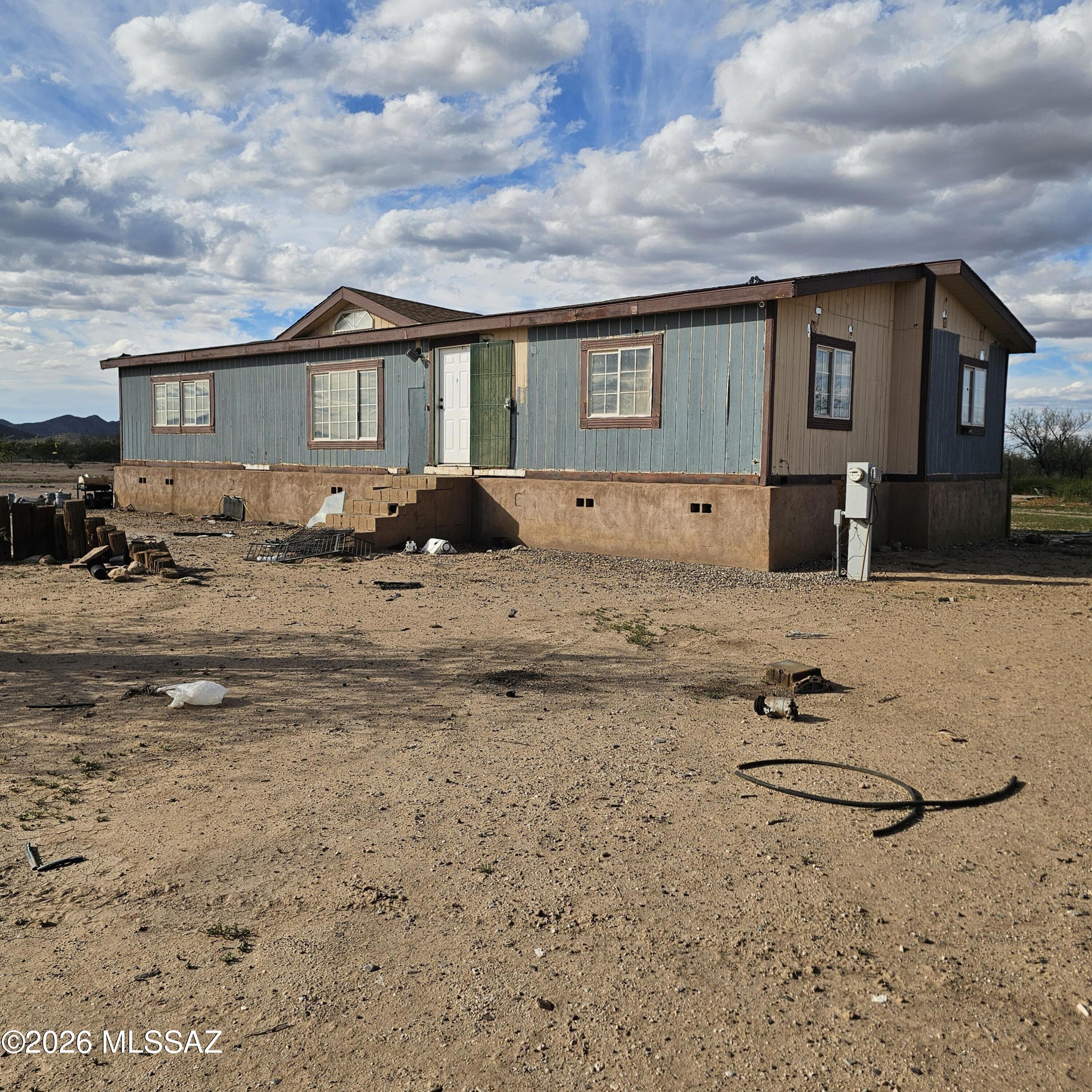 Unlock the potential of this rare 4.64-acre property in Three Points, offering endless possibilities for those with vision. Tucked away for ultimate privacy and surrounded by wide-open desert, this 3-bedroom, 2-bath home is the perfect opportunity for investors, renovators, or buyers looking to create their own secluded retreat. The home is in need of renovation, making it an ideal project to customize, update, and truly make your own. With this much land, there's room to expand, add additional structures, store equipment, or simply enjoy the space and freedom that's hard to find. Whether you're looking to flip, invest, or build your dream homestead, this property offers the foundation to bring your ideas to life, all at a compelling value. Owner is a licensed agent.